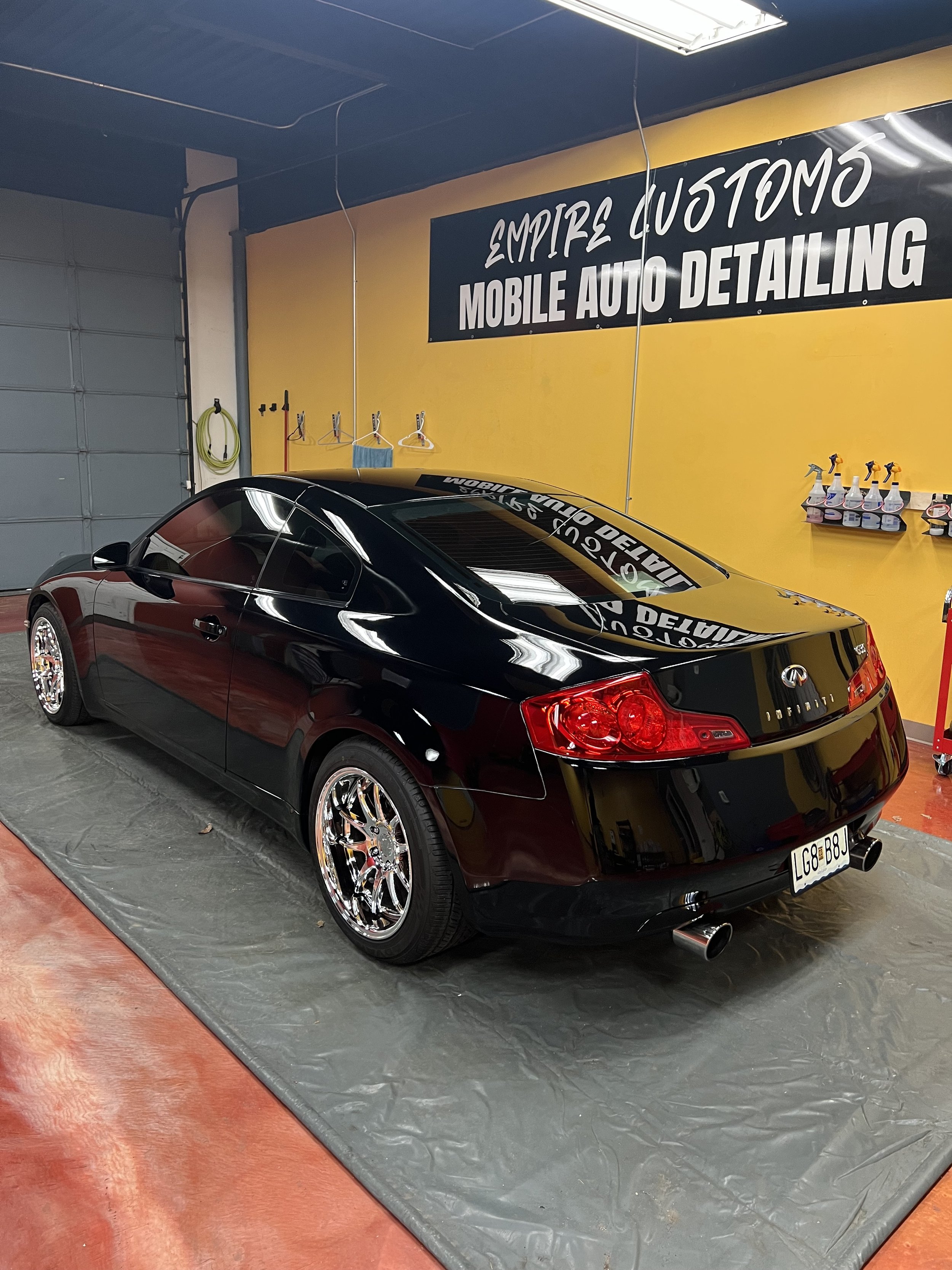 Car panel under inspection light showing swirl marks being corrected for a smooth mirror like finish.