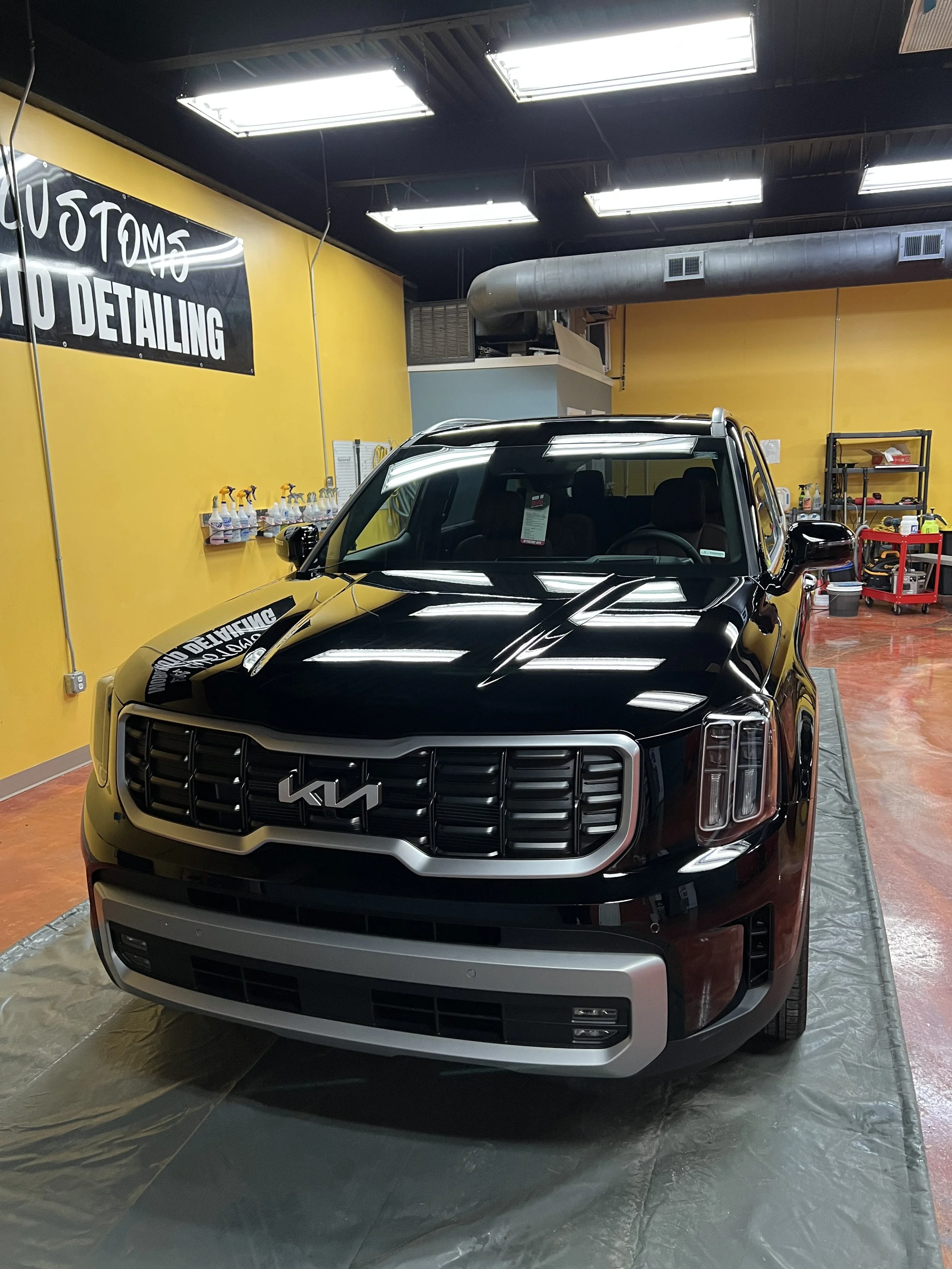 Car undergoing professional paint correction to remove oxidation scratches and swirl marks for a mirror like finish.