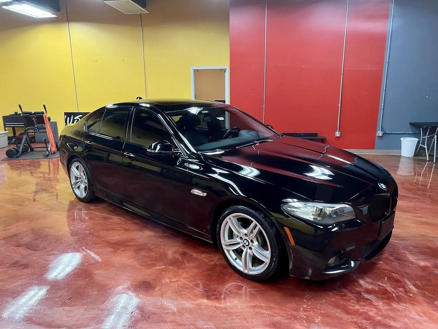 Luxury vehicle receiving ceramic window tint installation for UV protection and interior cooling.