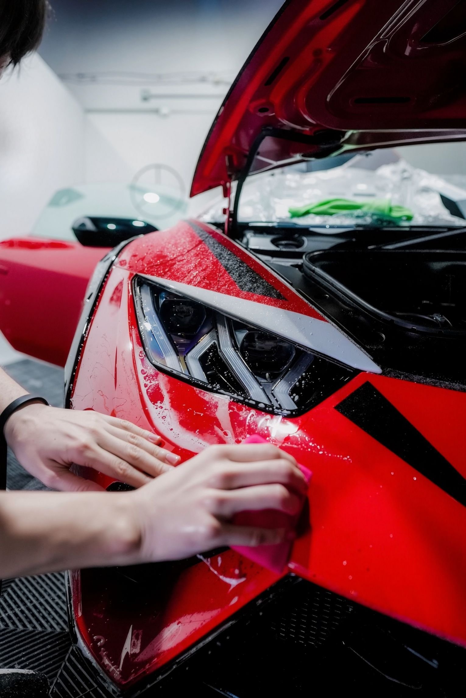 Close up of clear self healing paint protection film applied to car bumper for long term protection.
