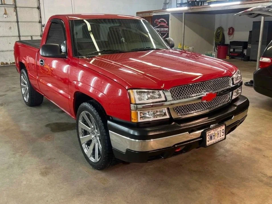 Detailer applying ceramic coating to luxury vehicle after paint correction in Kansas City.