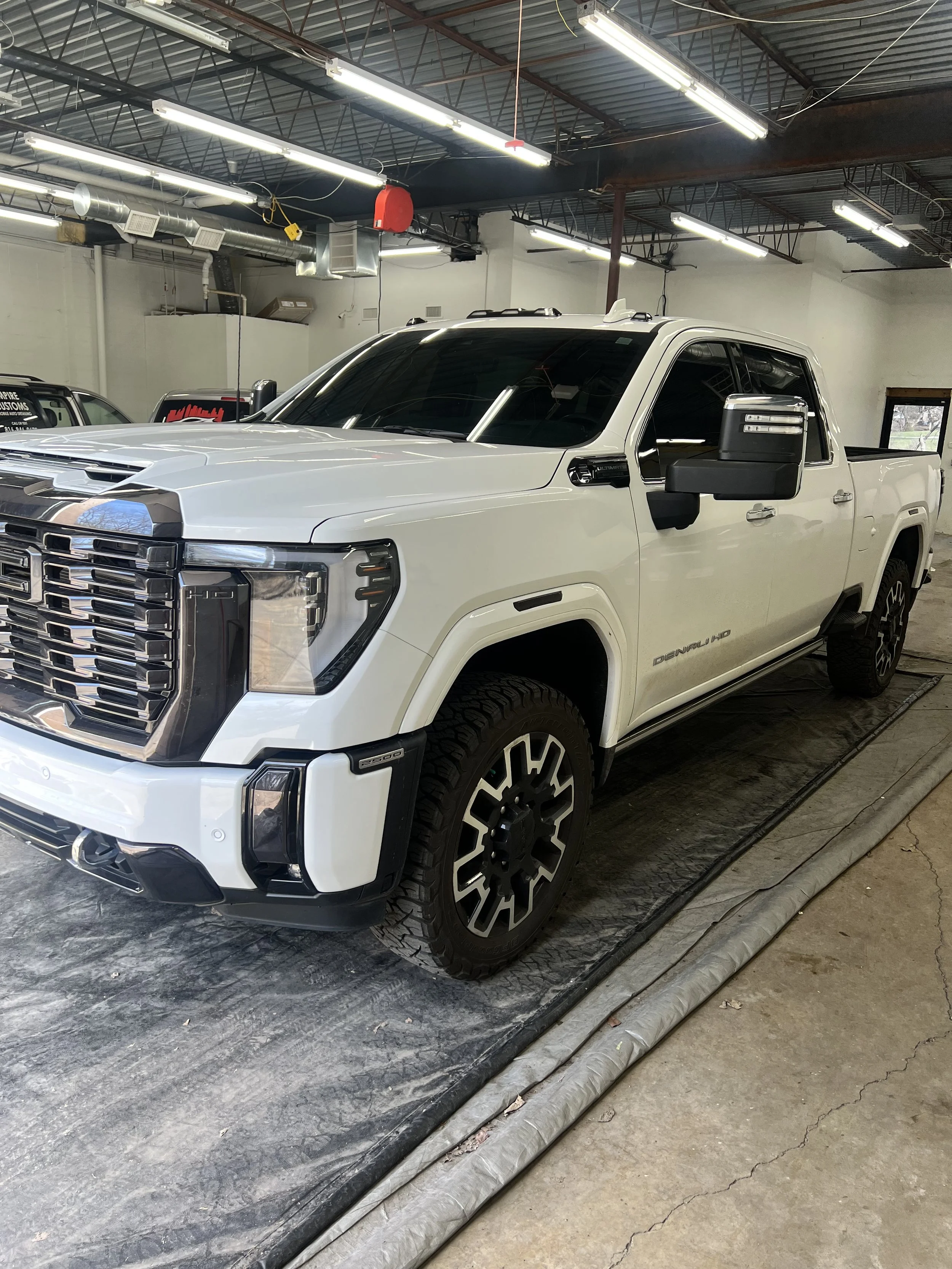 SUV receiving a full wash and wax treatment showing improved shine and clean exterior surfaces.