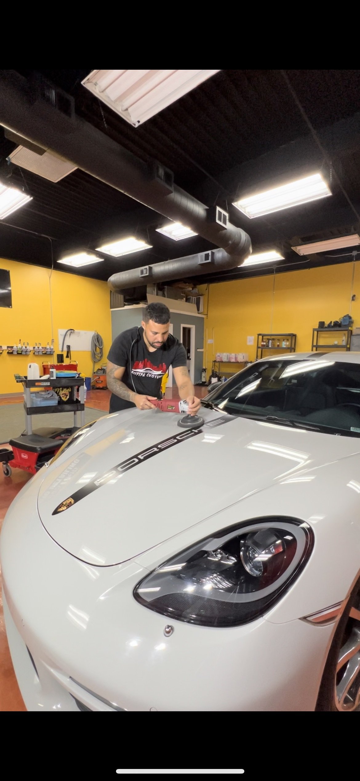 Professional paint correction on a car at Empire Customs Car Detailing in Kansas City restoring gloss by removing swirls scratches and oxidation from the paint surface.