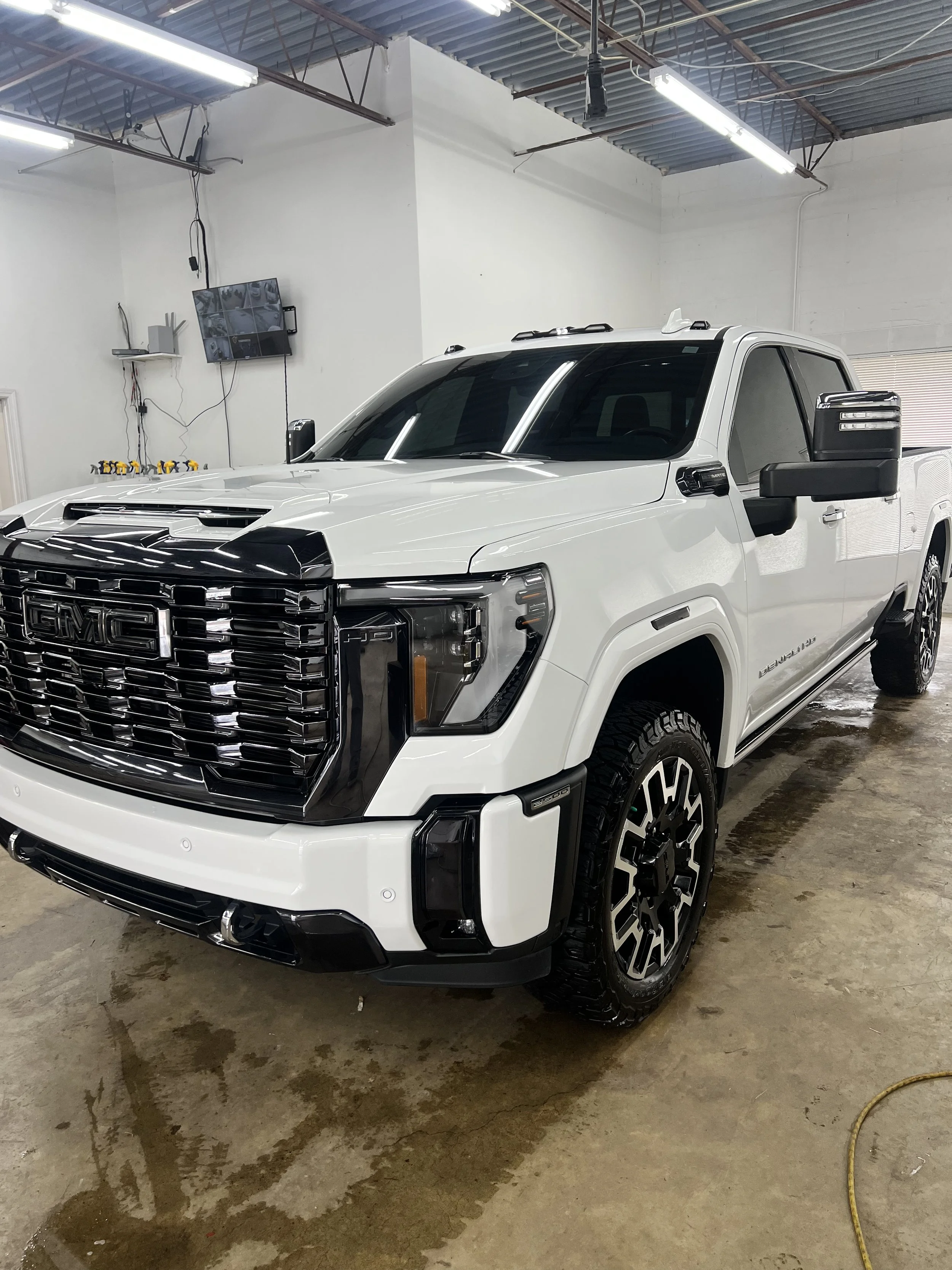 Before and after paint correction comparison on a black car highlighting restored shine and deeper gloss.