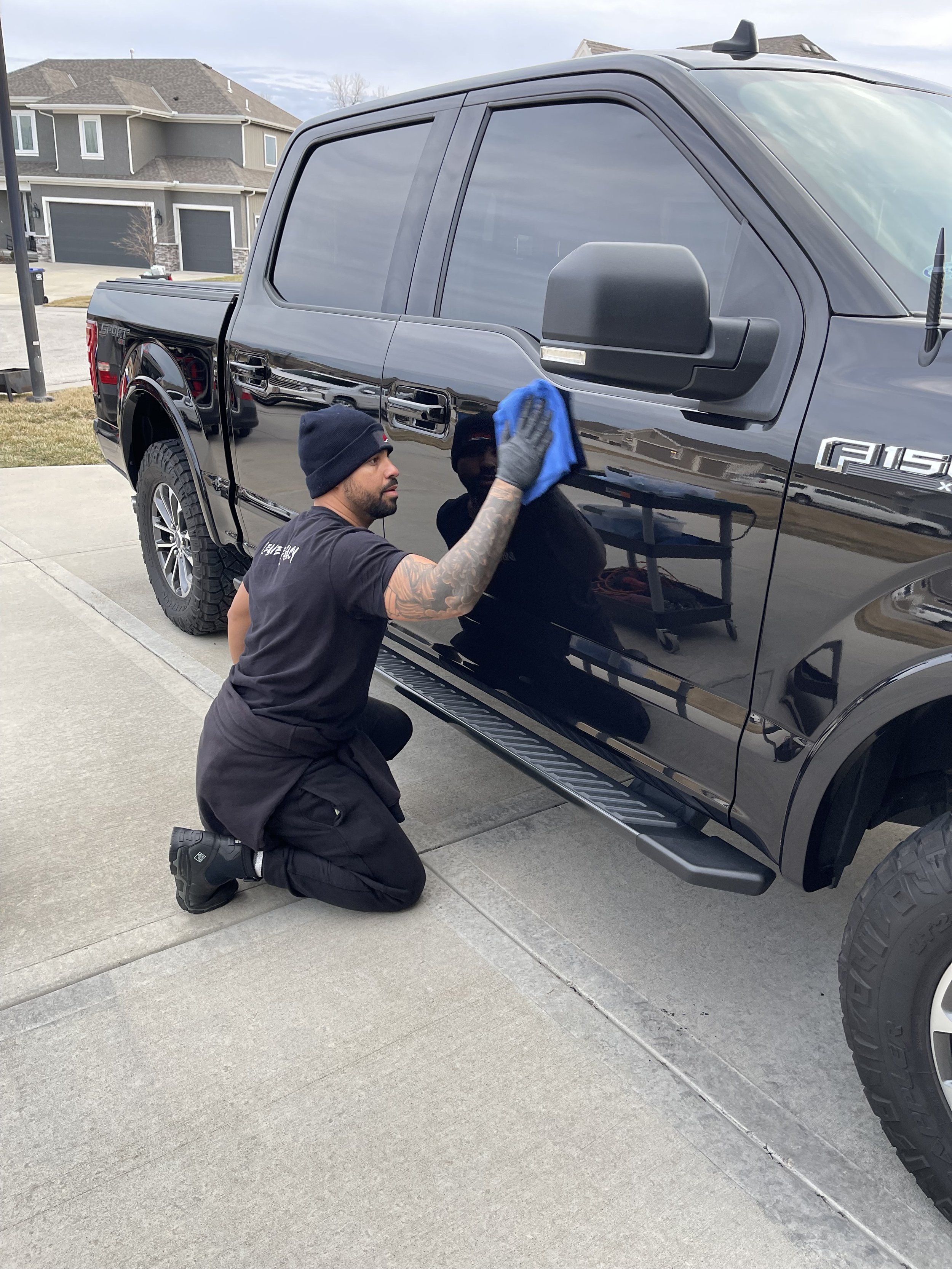 Empire Customs Car Detailing Ceramic Coating & PPF technician detailing a truck in Kansas City, performing a full interior and exterior cleaning with paint polish and protection.
