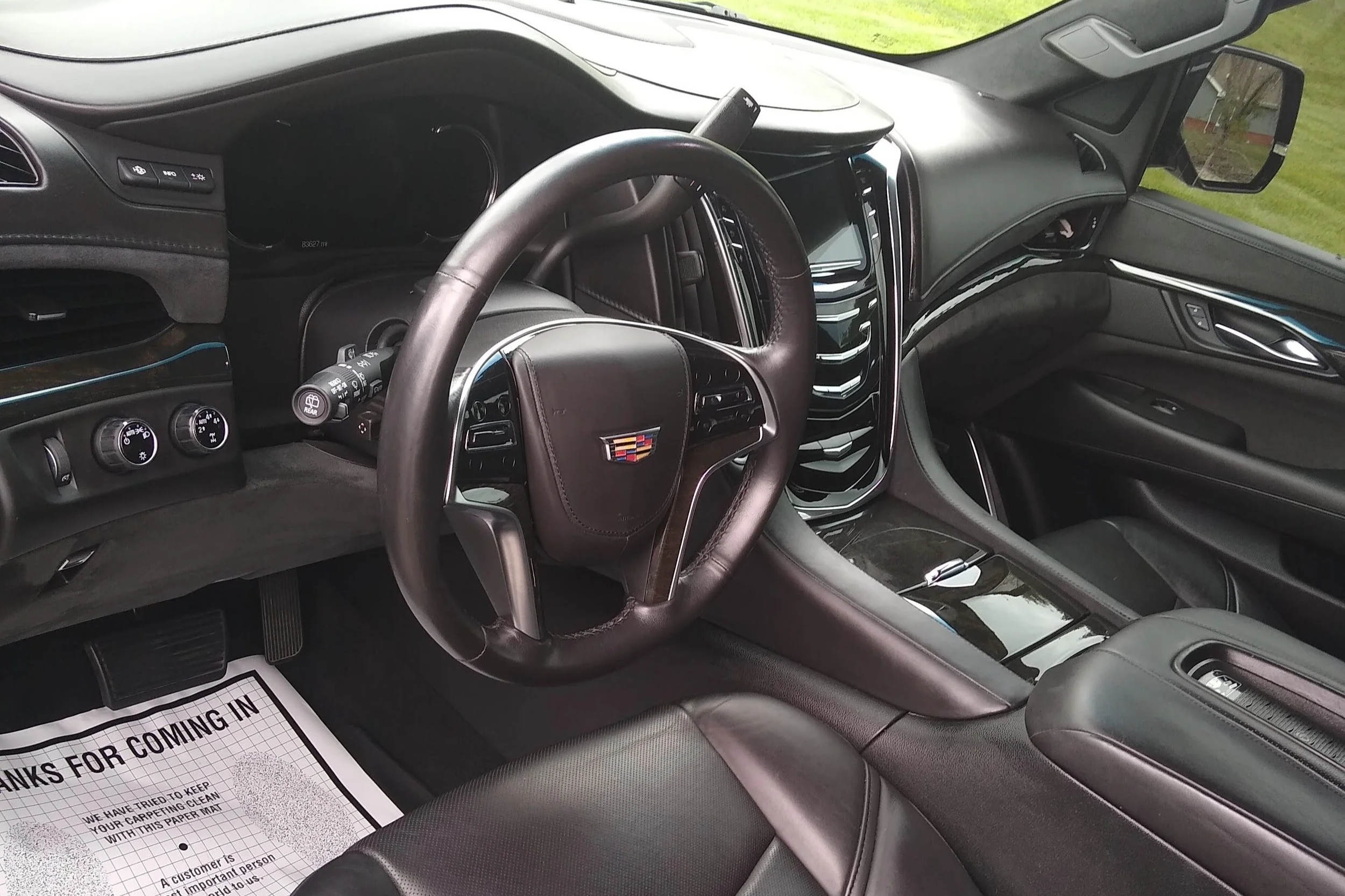Detailer shampooing car seats during a full interior detail to remove stains dirt and odors.