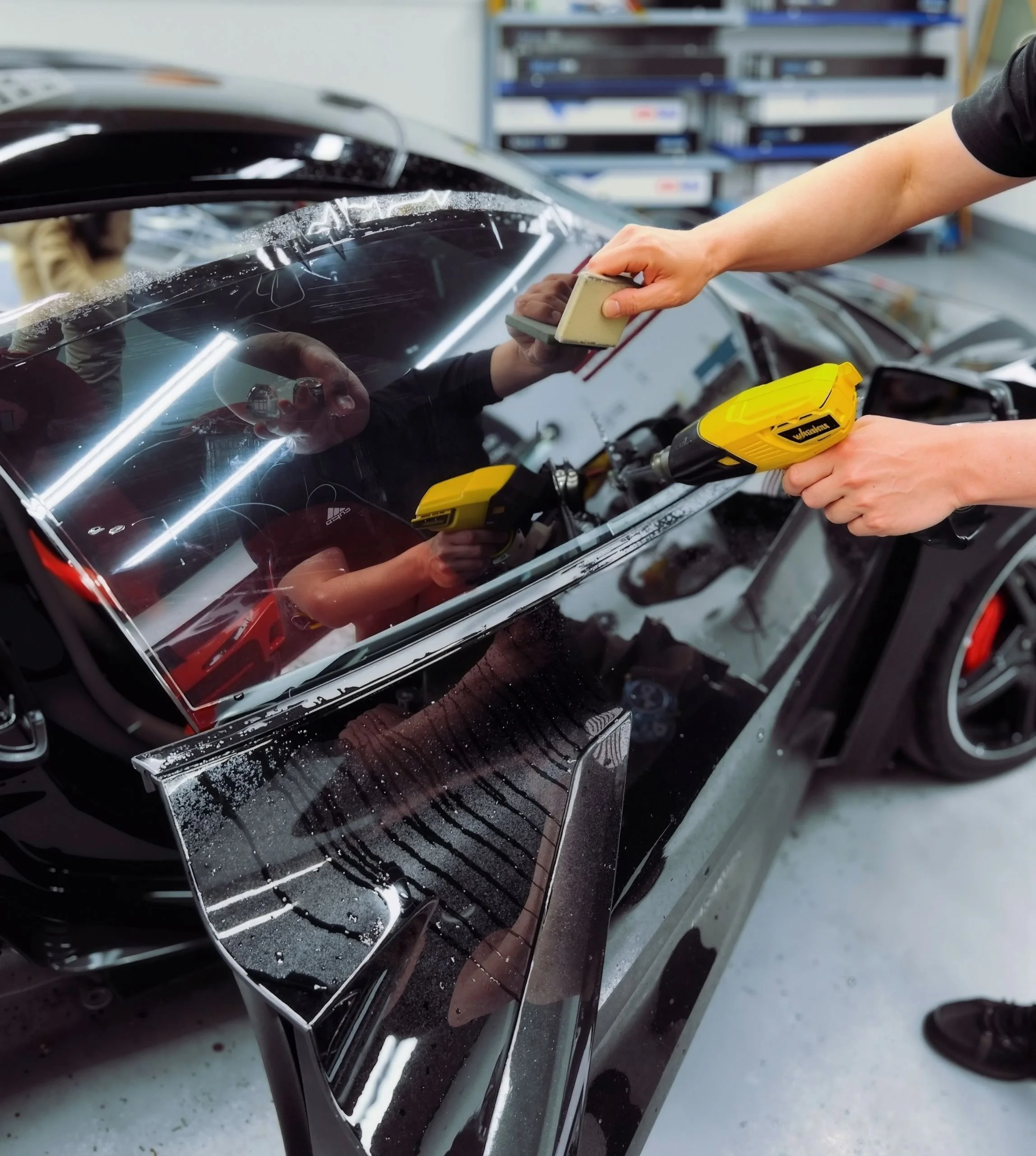 Tesla Model 3 with freshly tinted windows at Empire Customs Car Detailing in Kansas City for privacy and interior cooling.
