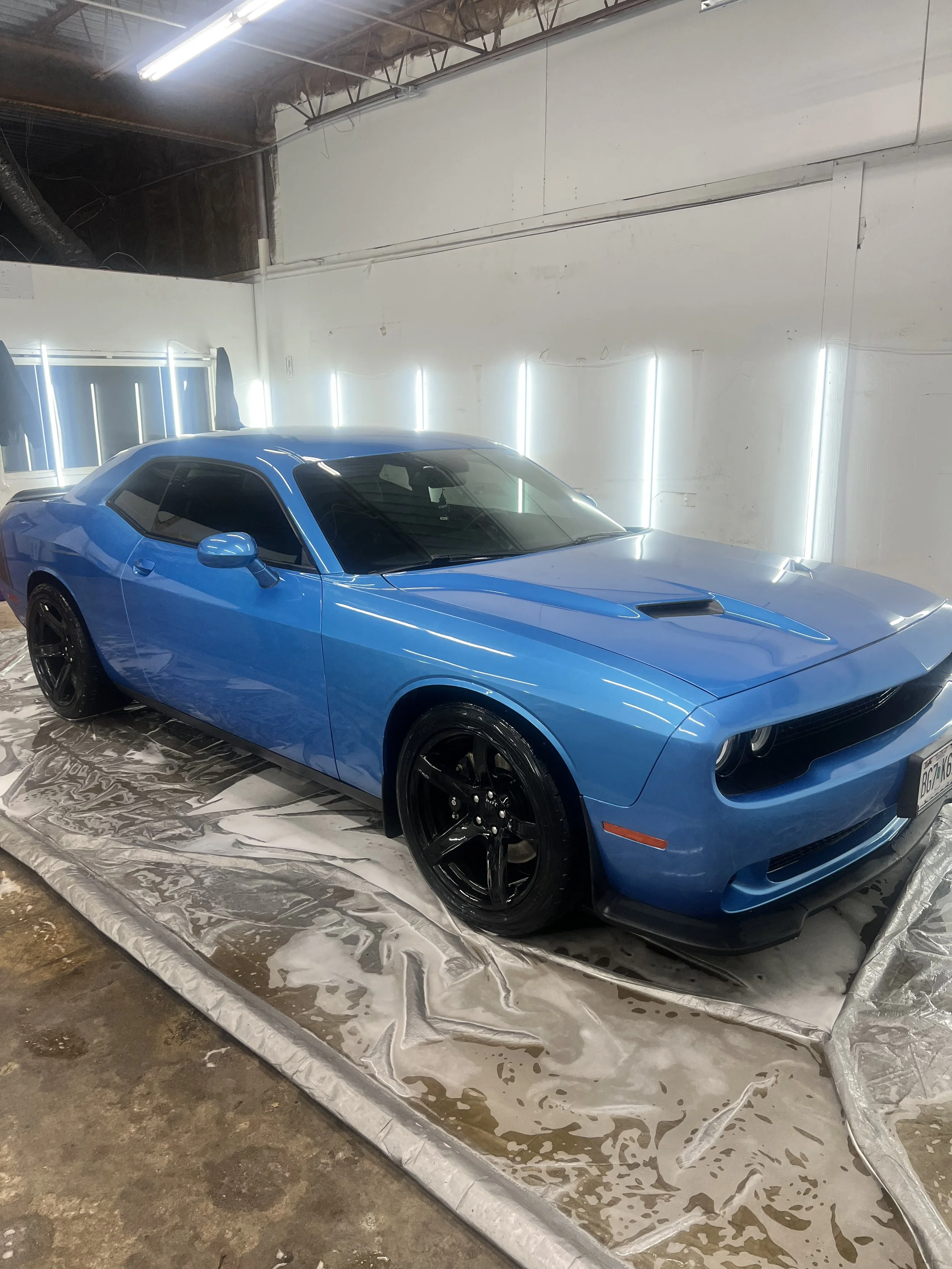 Close up of a clay bar being used to clean the paint before applying wax for a smooth finish.