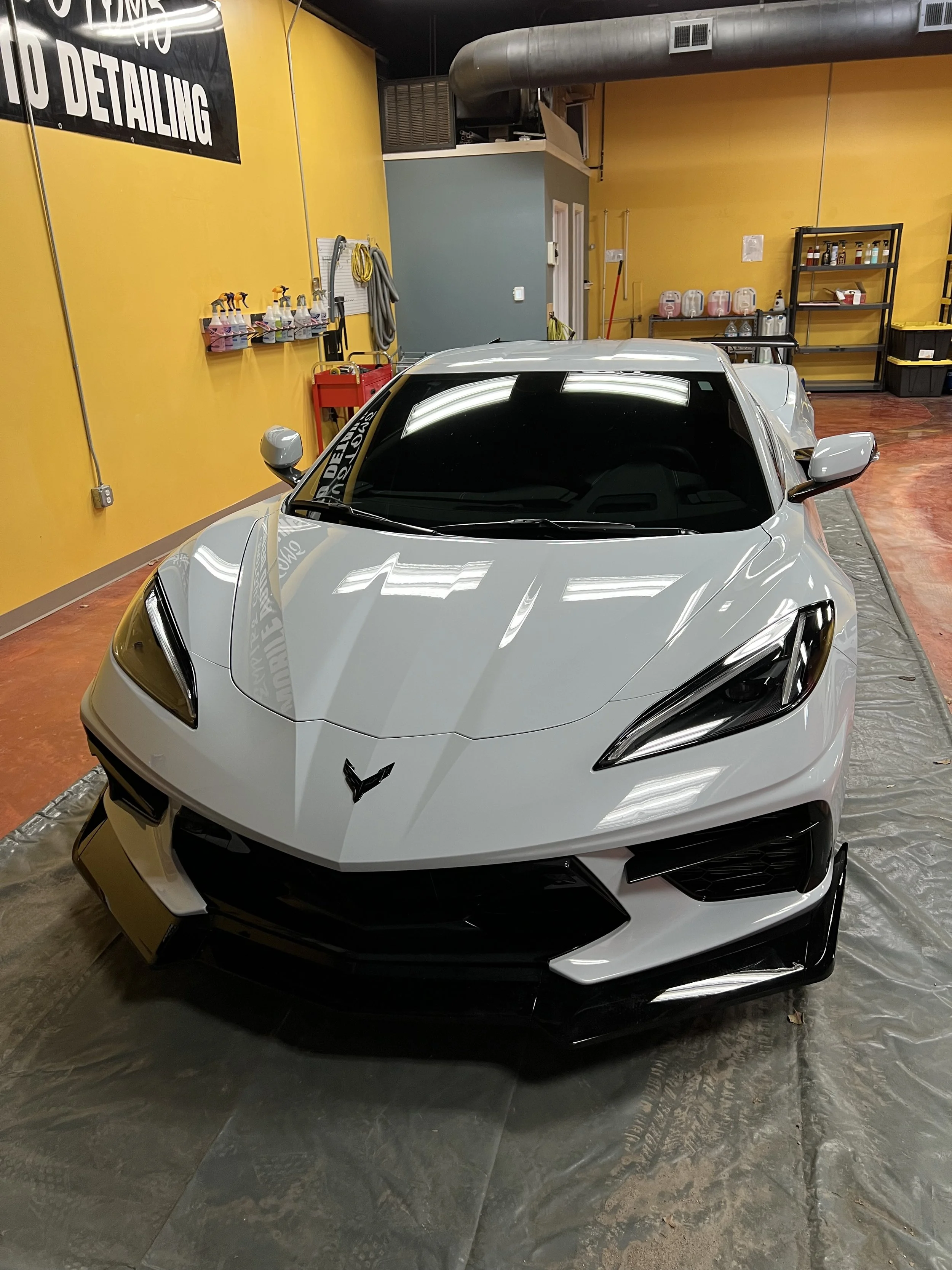 Full front paint protection film wrap on a black SUV showing seamless edges and a glossy finish.