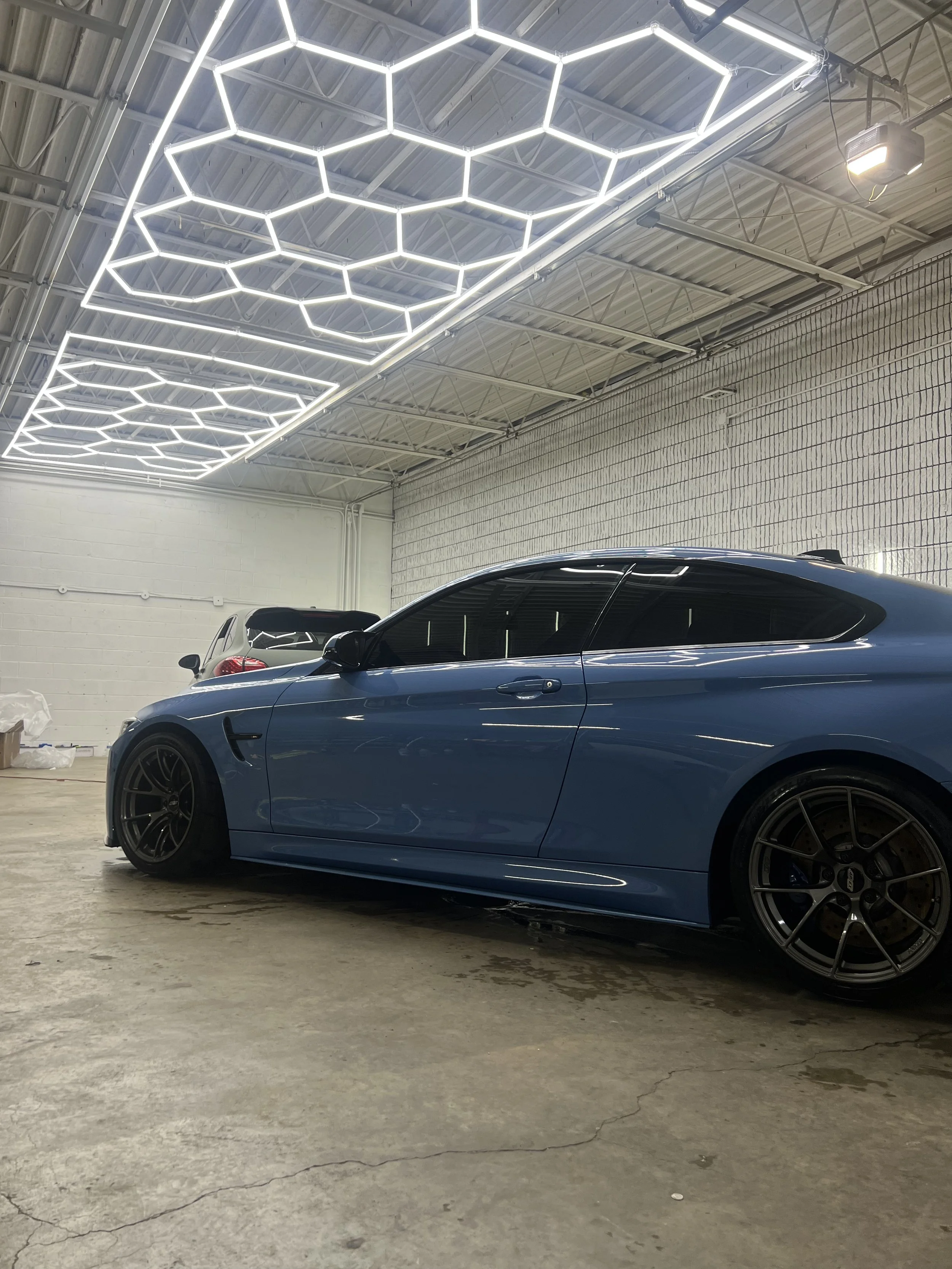 Hydrophobic ceramic coating beading water on freshly coated vehicle surface.