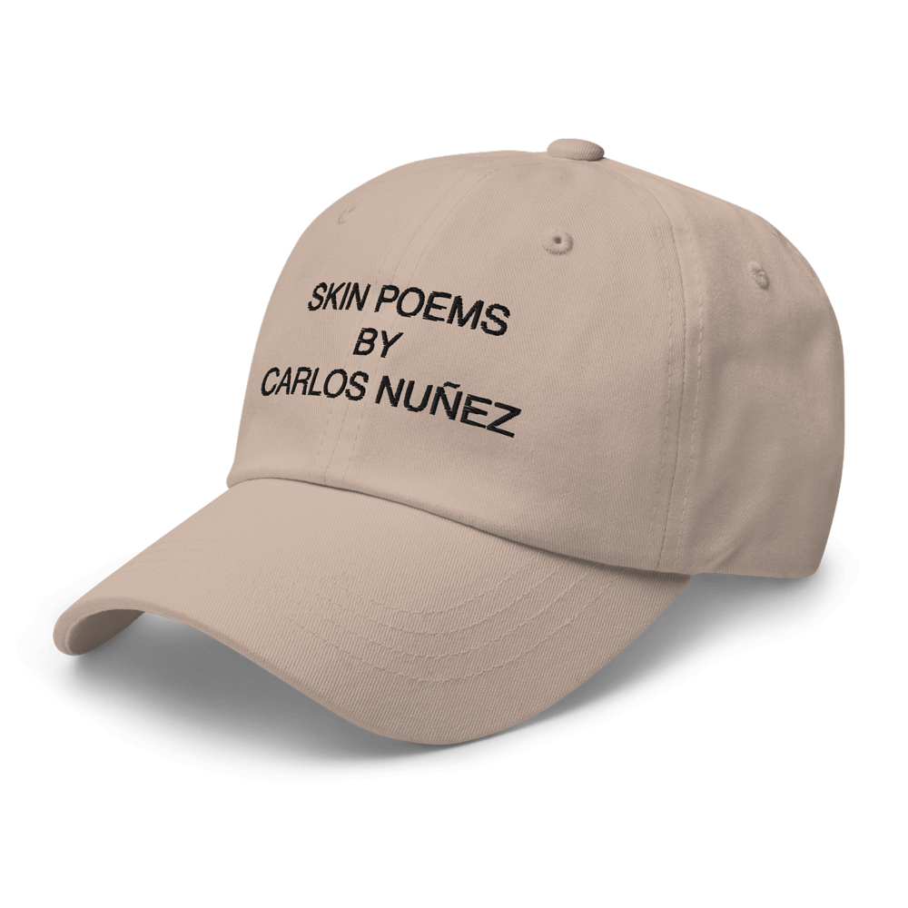 Tan color dad hat with Skin Peom embroidery.