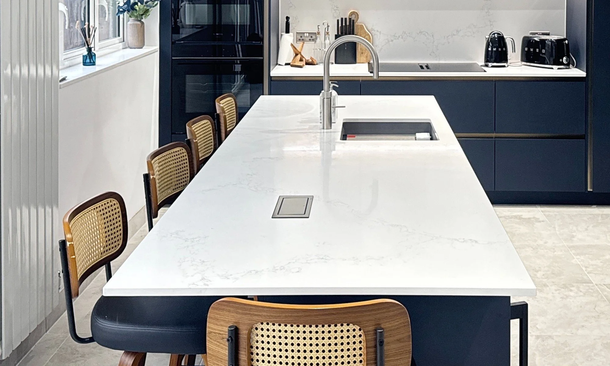 quartz worktop on kitchen island in a blue modern kitchen