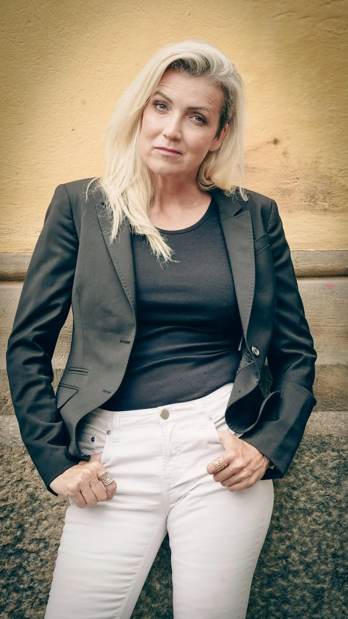 Portrait of Mirjam outdoors next to building wall