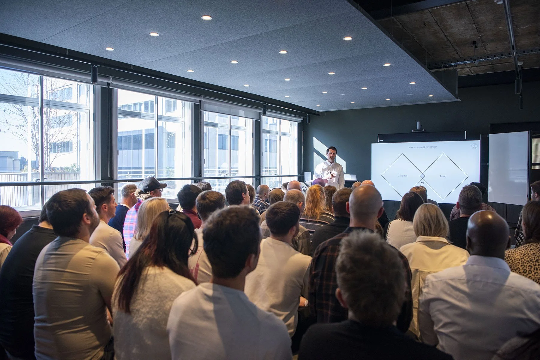 Photo of packed audience listening to speaker, Tom Belt, at Let's talk about CX event at Leeds Digital Festival 2025.