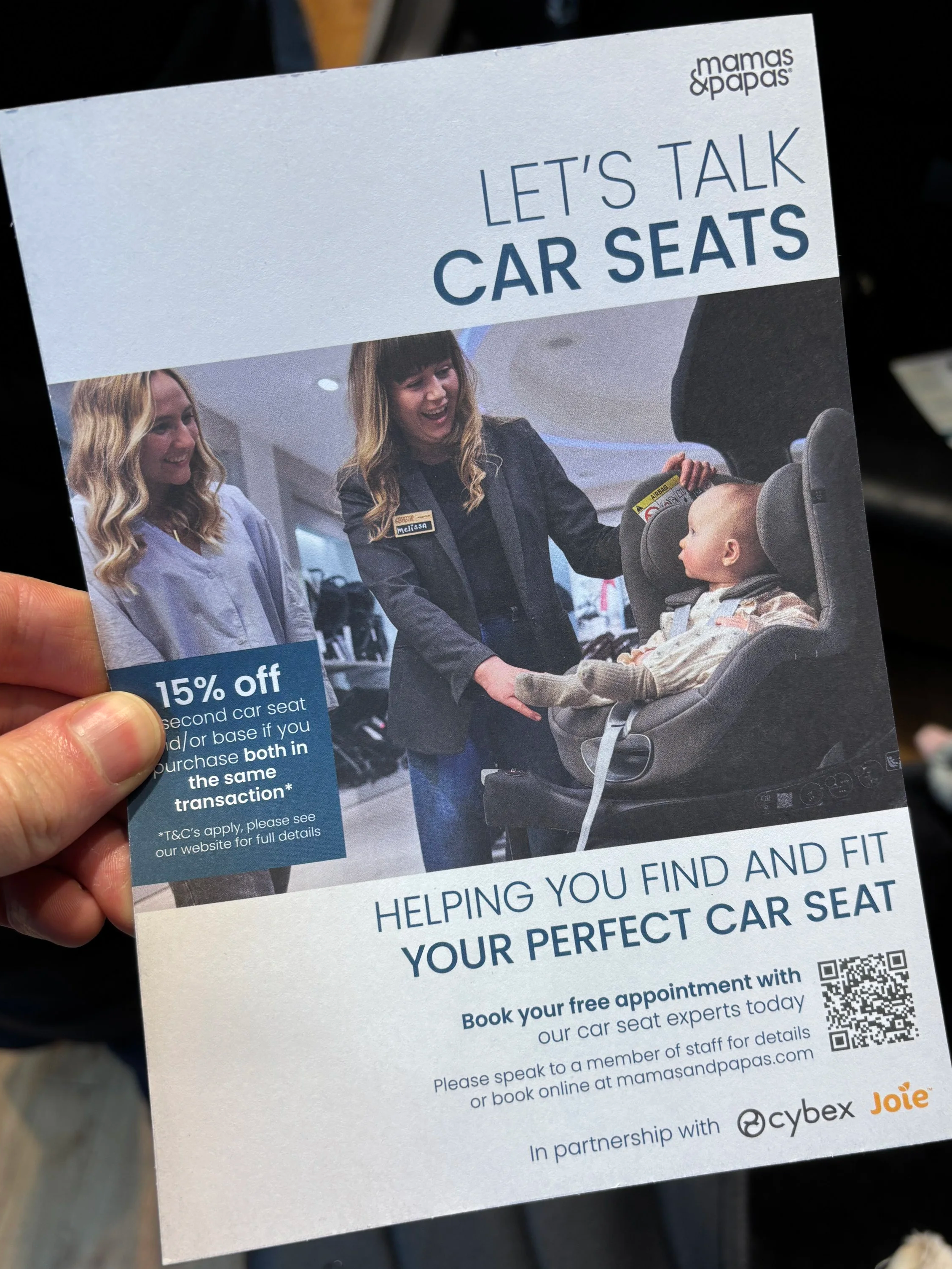 Photo of a flyer given to customers at Mamas&Papas stores to promote booking a car seat appointment via a QR code