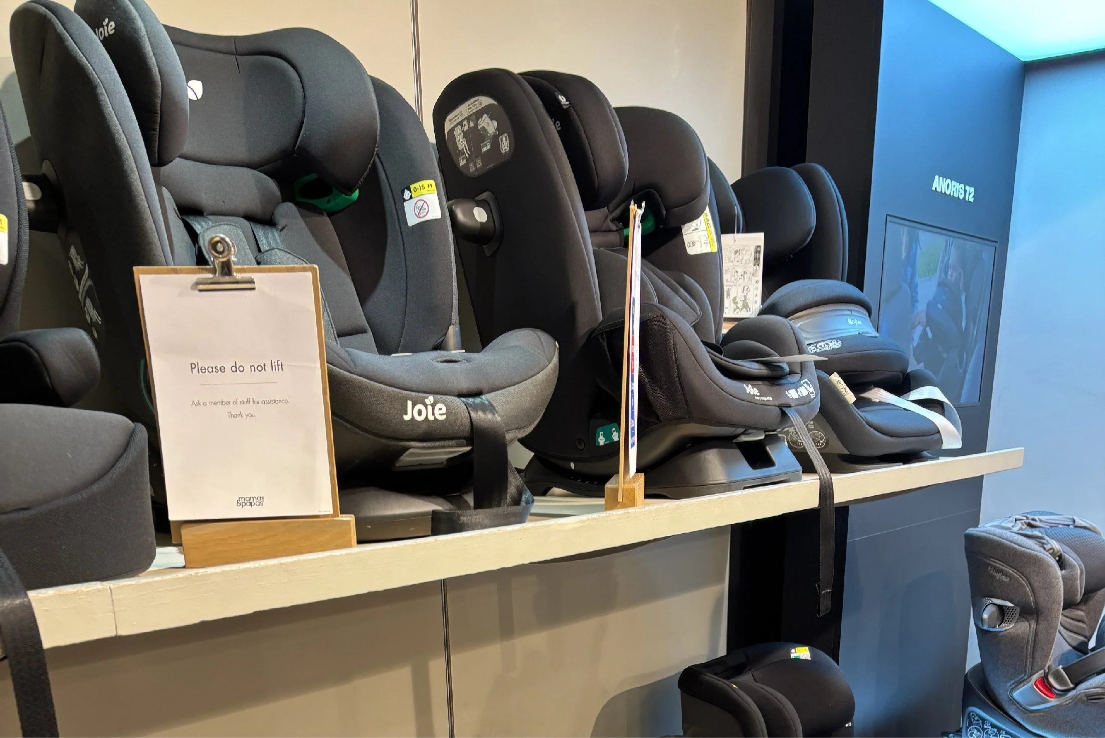 Photo of a selection of child car seats on the shelves of a Mamas & Papas store