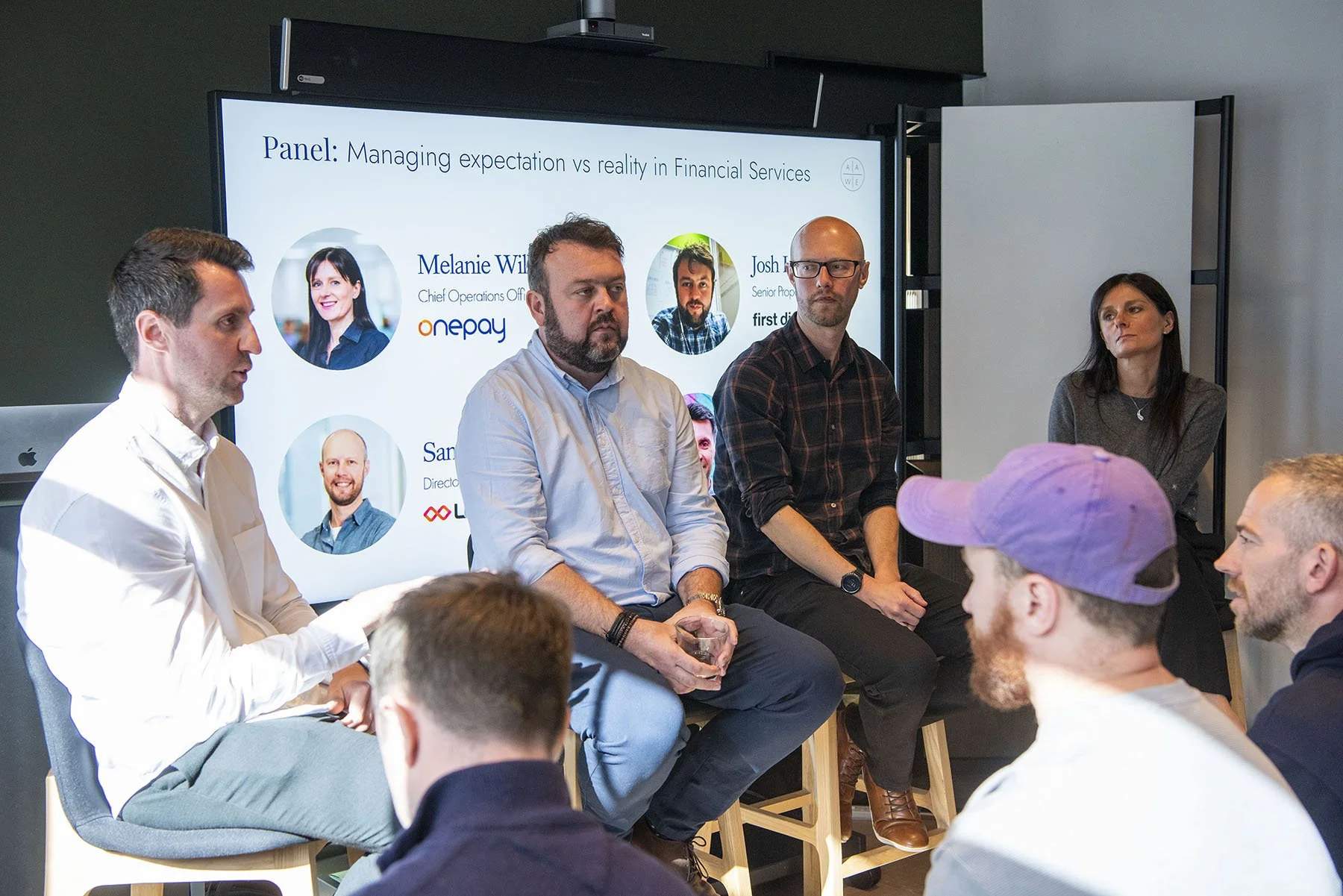 A photo of a panel discussion featuring leaders in CX and AAWE founder, Tom Belt.