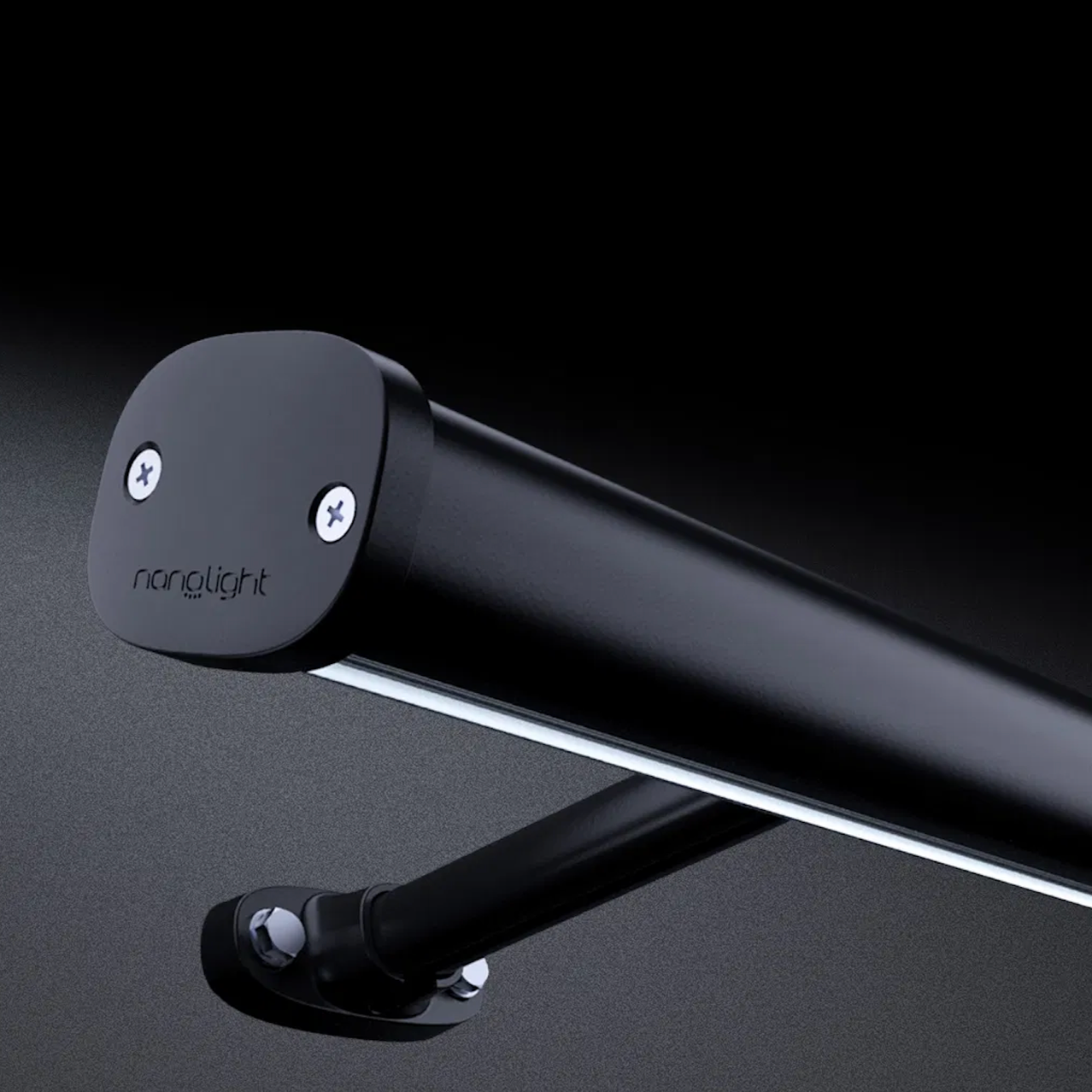 Close-up of a black cylindrical motor mount attached to a flat surface with screws, labeled 'nanolight'.