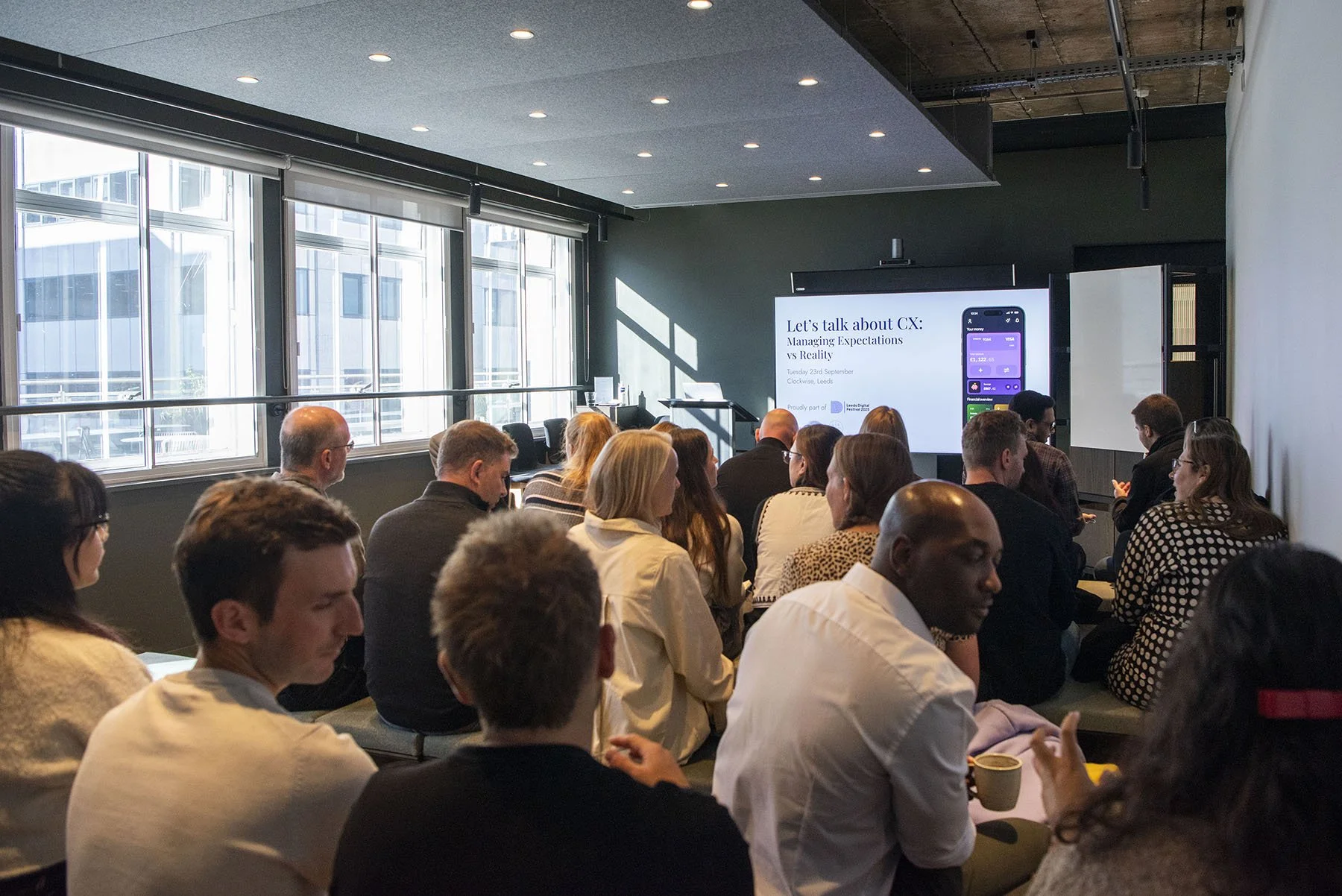 A photo of a crowded room ahead fo the start of the 'Let's talk about CX' event hosted by AAWE.