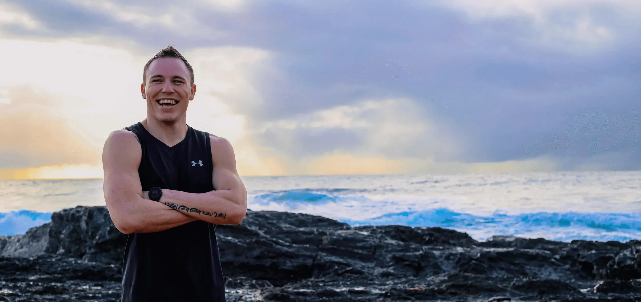 Jacob Little standing by the ocean with arms crossed, representing confidence after resolving a car accident compensation claim