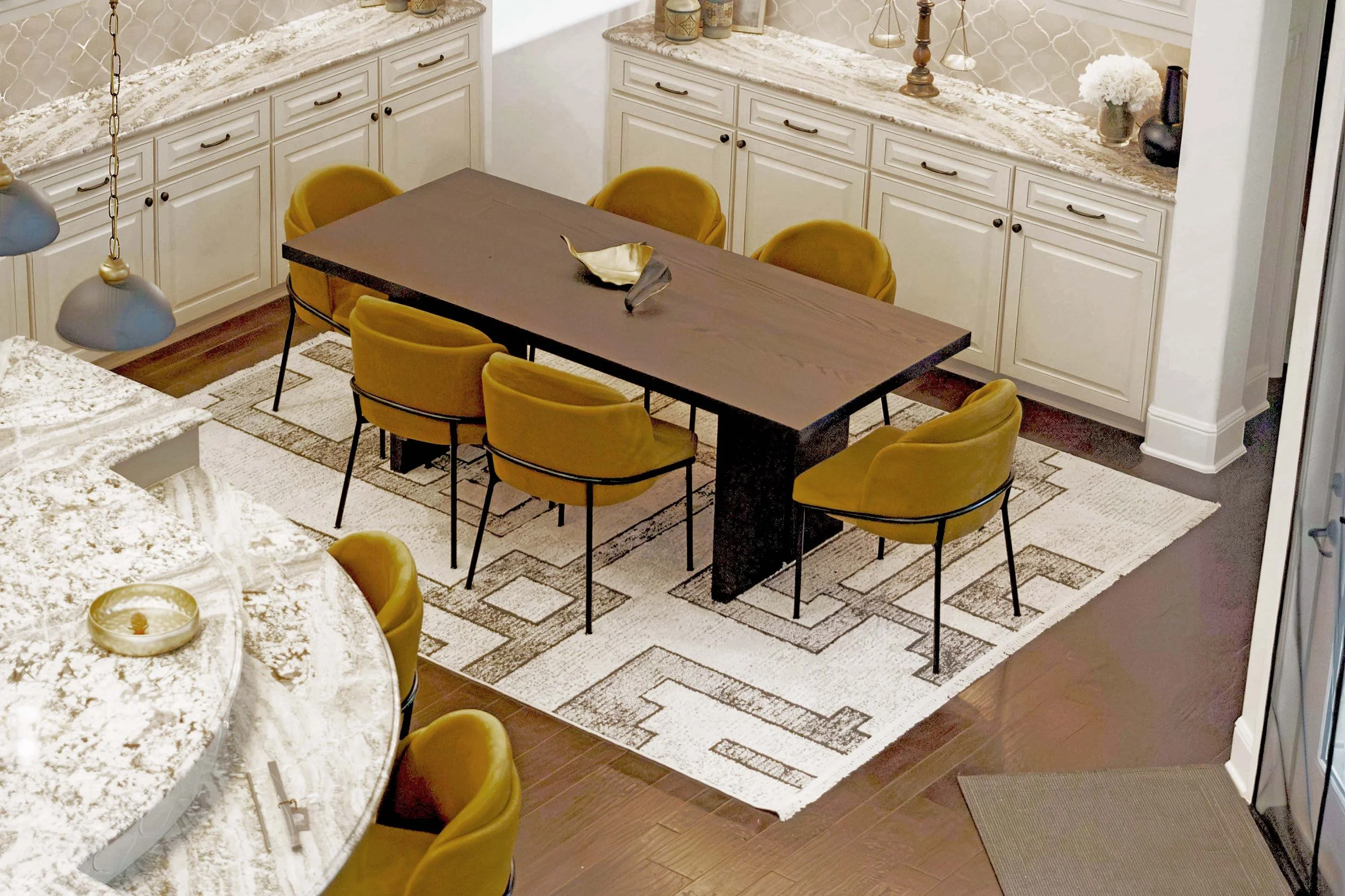 The open-concept Dining Room needed some life. We softened the lines here with some incredibly sturdy barrel back dining chairs in mustard tones.