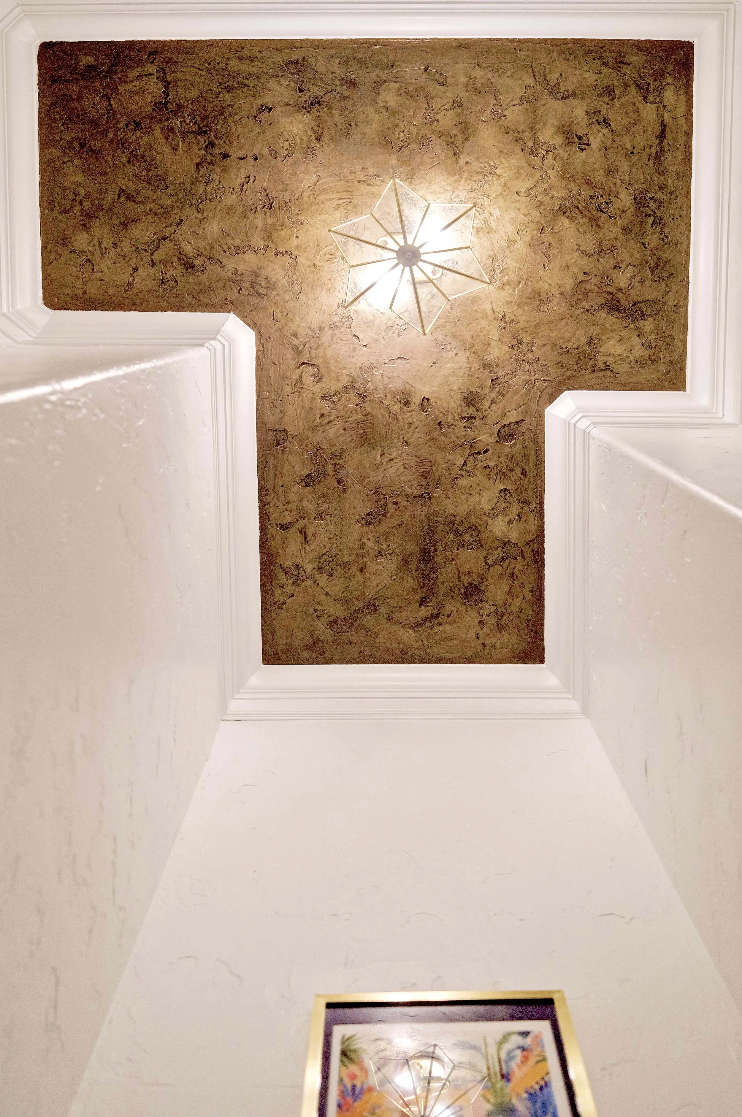 When you are dealing with a floor plan that is anything but standard, you can either ignore it and hope it goes away or you can feature it and make it shine. So we did with a special ceiling treatment and a light to illuminate it further.