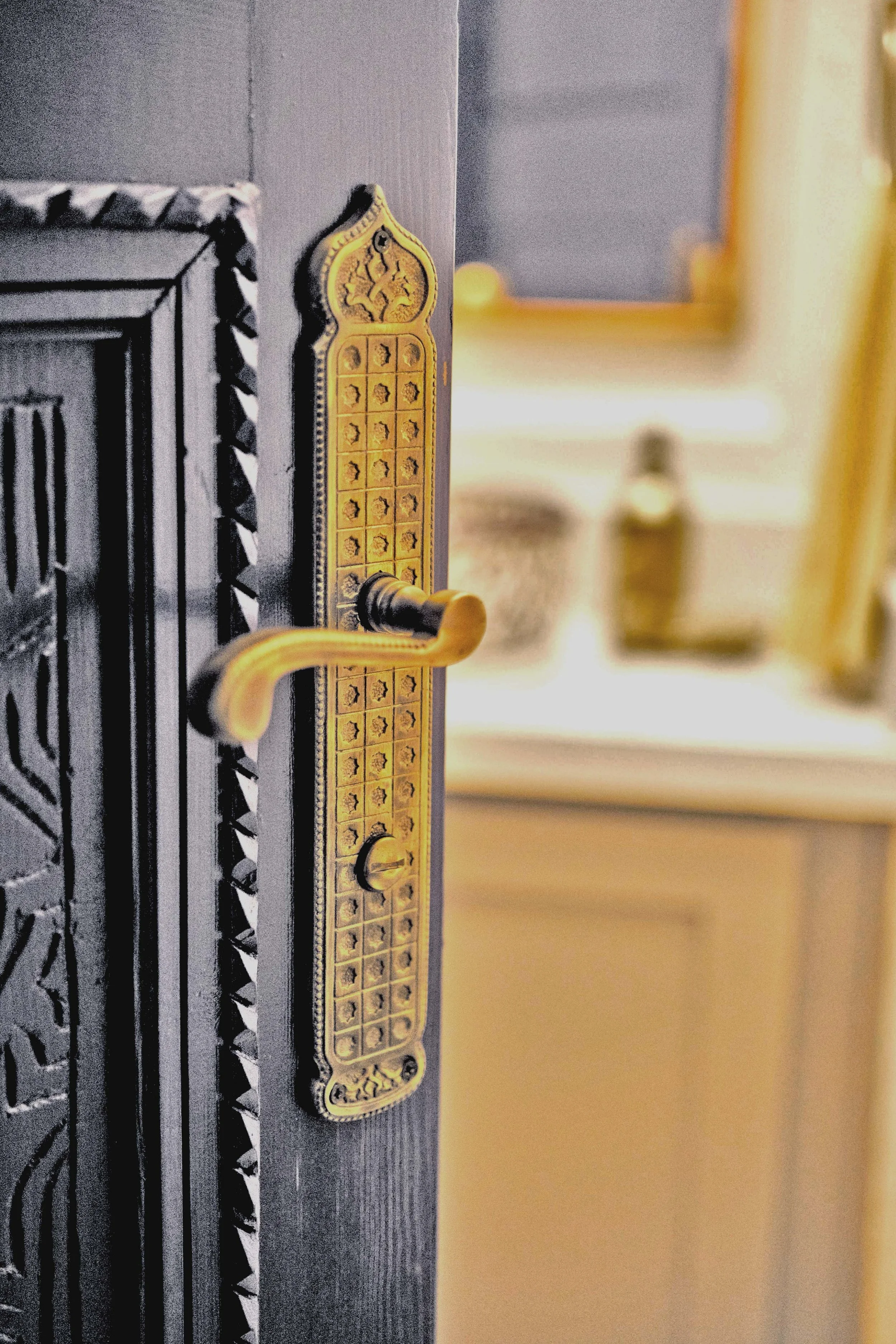 A detailed view of a brass door handle imported from Morocco.