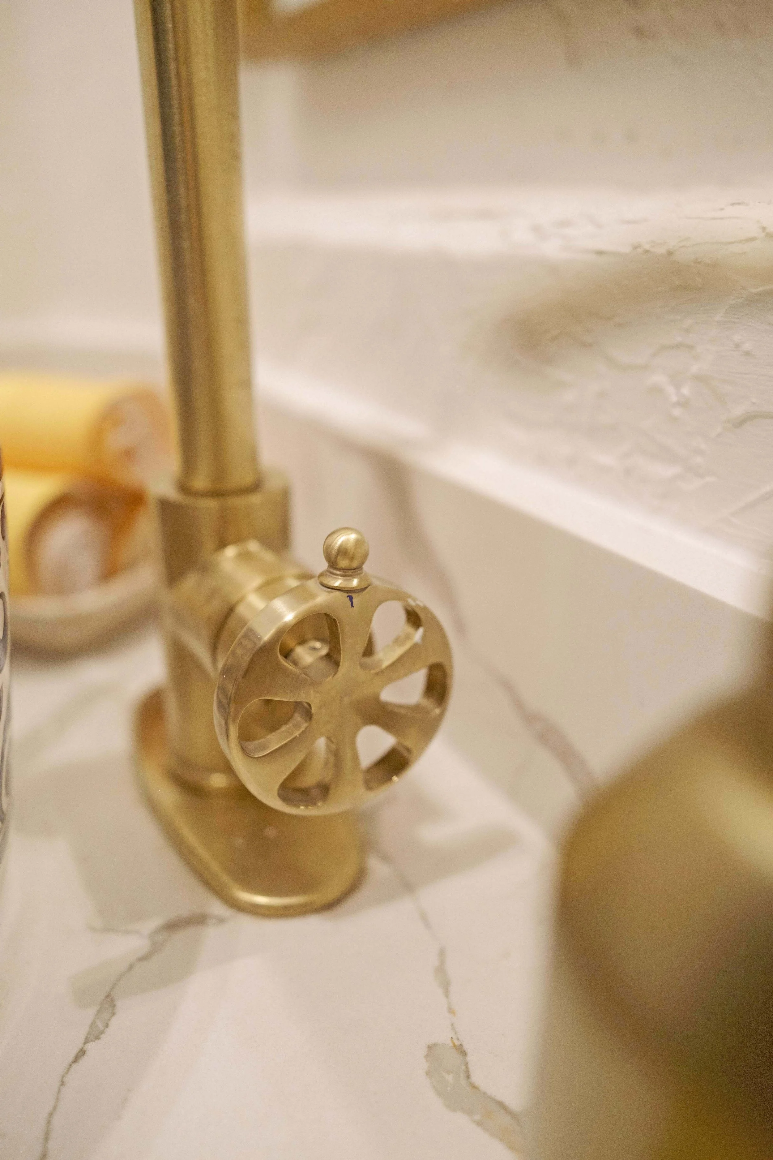 A close up of the brass faucet handle.