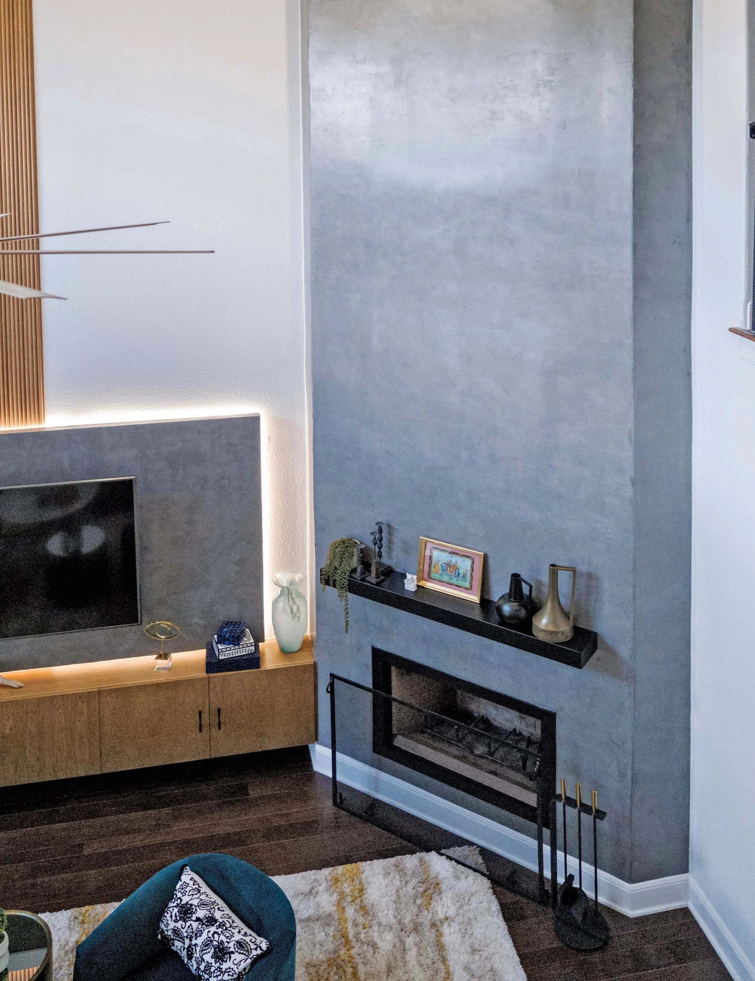 The corner fireplace used to be an eyesore. We turned it into a feature with a plaster treatment that draws your eye up and highlights the high ceiling.