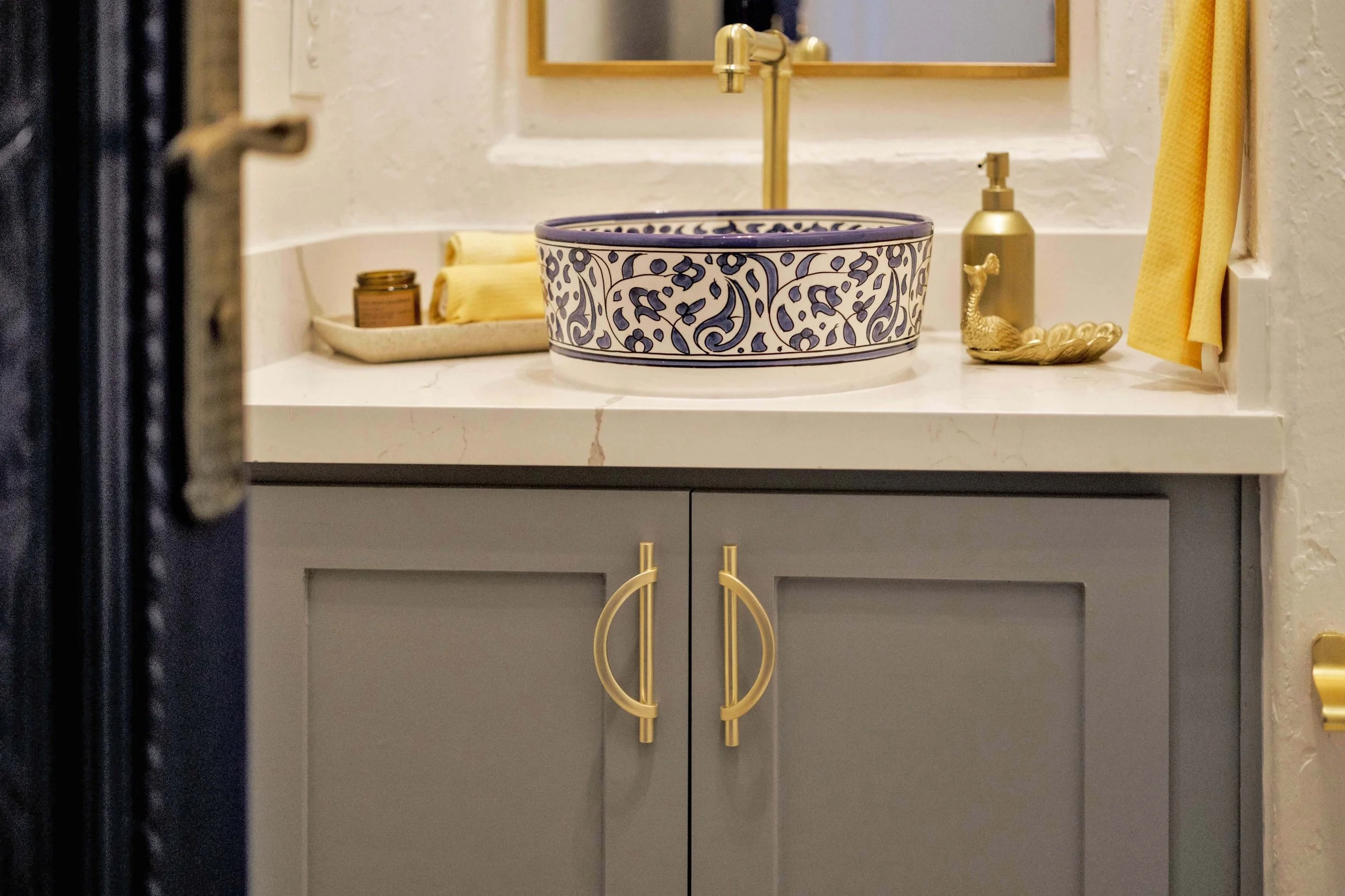 Custom cabinets are built into the wall and finished with unique door handles.