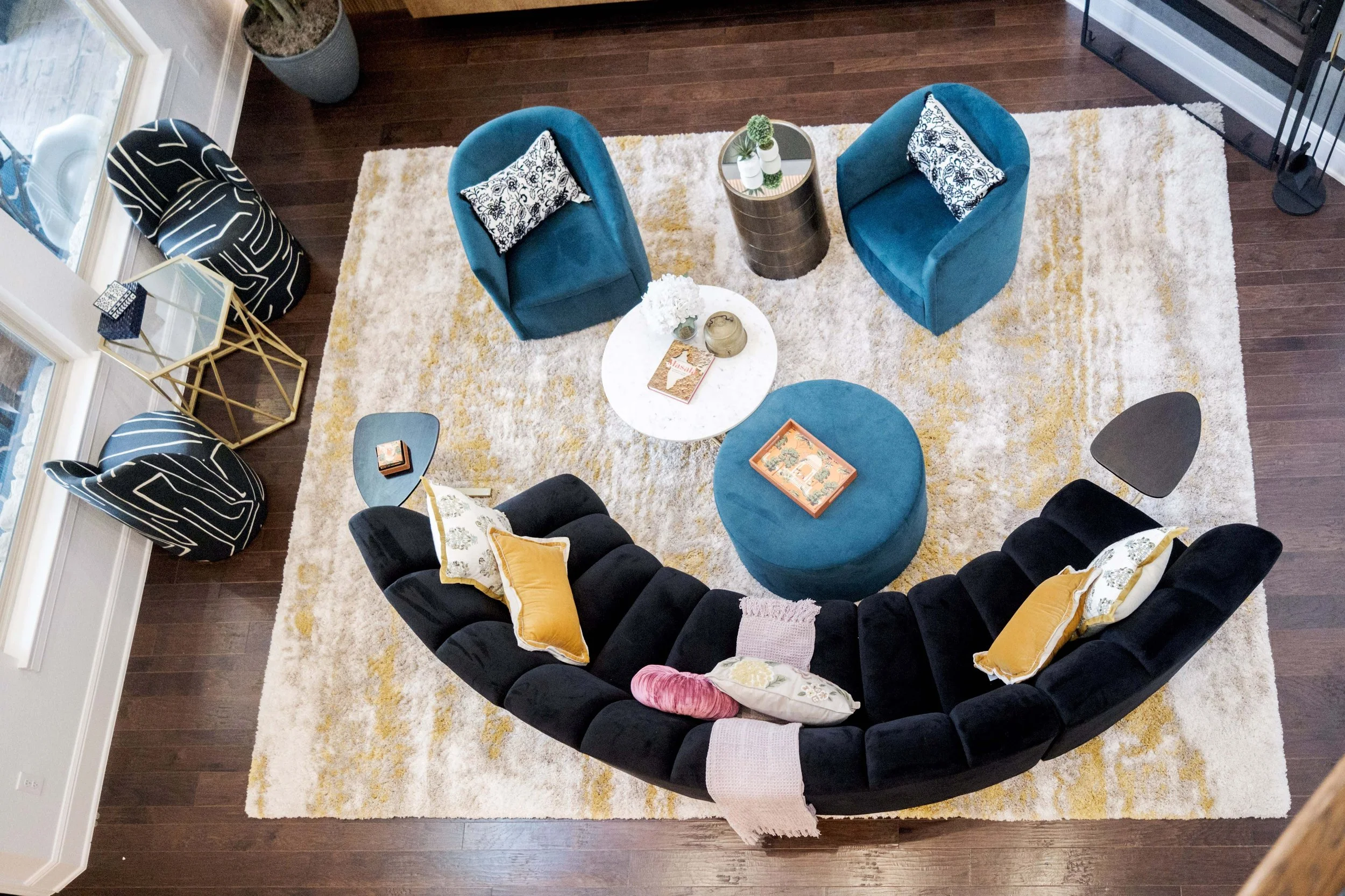 The Living Room features lovely 24' ceilings, with soaring windows, but a difficult layout. We combated this with a curved sofa and provided plenty of seating for this family.