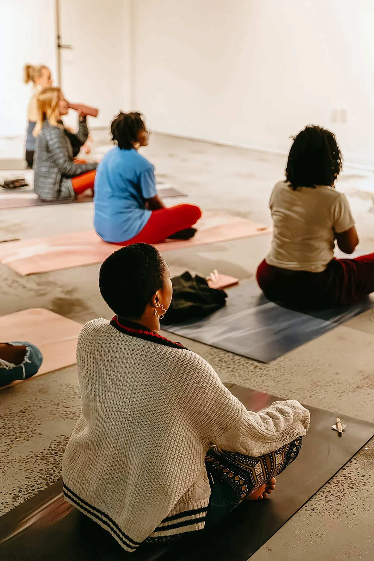 People on yoga mat deep breathing