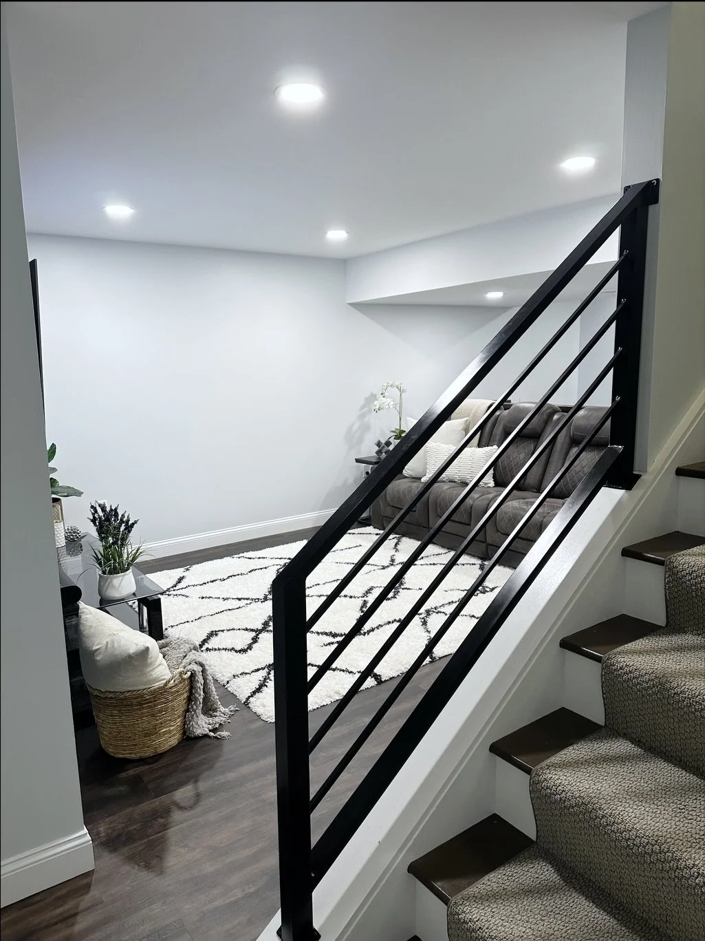 Finished basement living space in Lancaster, PA, remodeled by Vatter Construction with dark flooring and modern recessed lighting.
