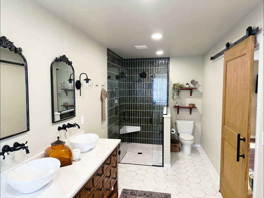 Modern-traditional bathroom remodeled by Vatter Construction with a wooden double vanity, walk-in shower, and green tilework.