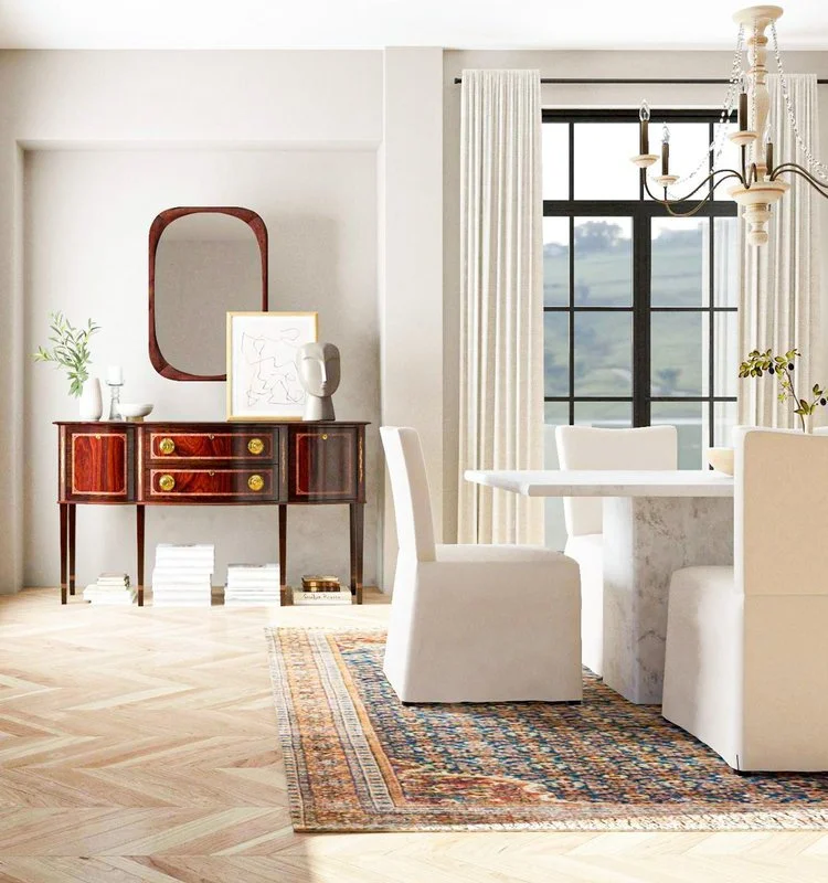 Elegant dining room combining an antique wooden sideboard with a white marble table, slipcovered chairs, and contemporary decor.