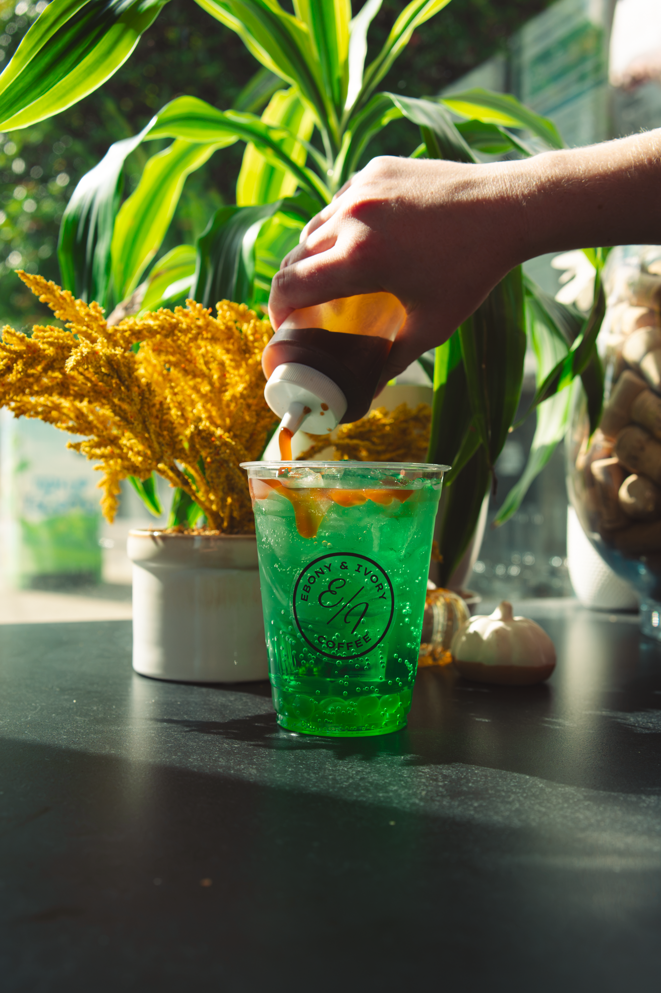 Bright green apple lotus energy drink with popping boba and caramel drizzle