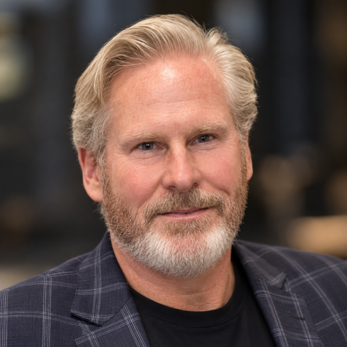 Dan Farr, Sound Support Foundation Advisory Board member, smiling portrait in a plaid shirt