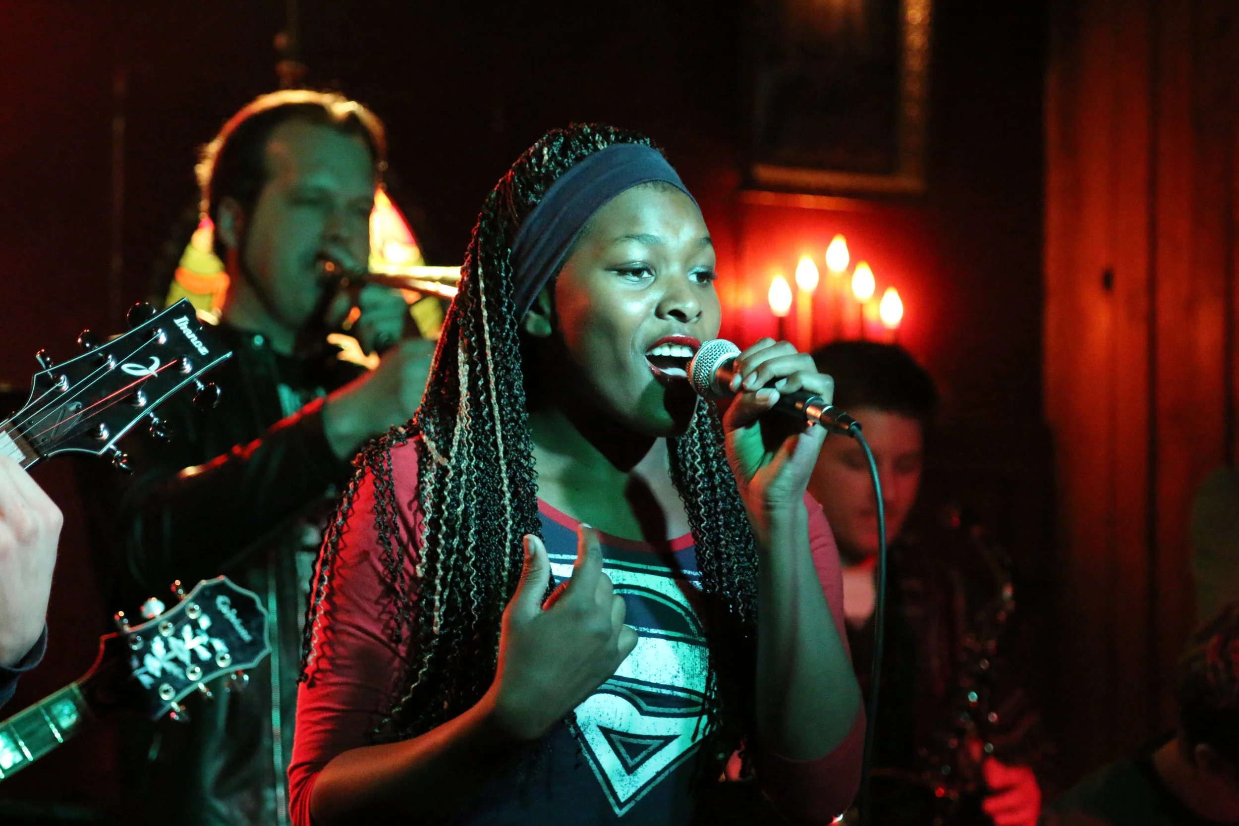 Young singer performing live with a band