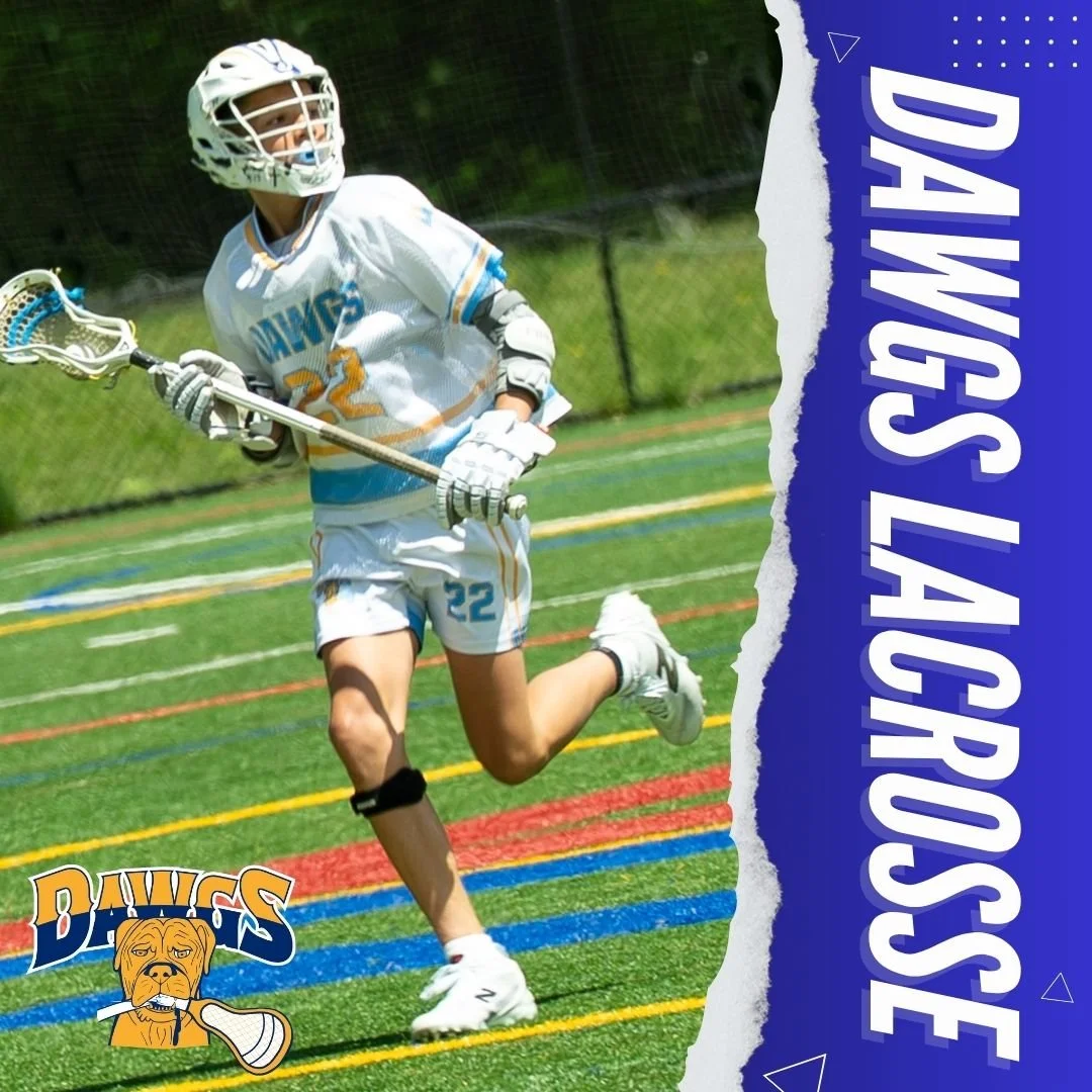 A young lacrosse player in a white and blue uniform running on a green turf field, holding a lacrosse stick, wearing a helmet, gloves, and protective gear.