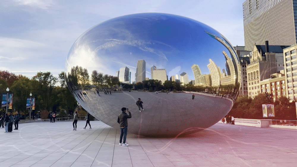 Cloud Gate sculpture in Millennium Park, Chicago, reflecting skyline and people