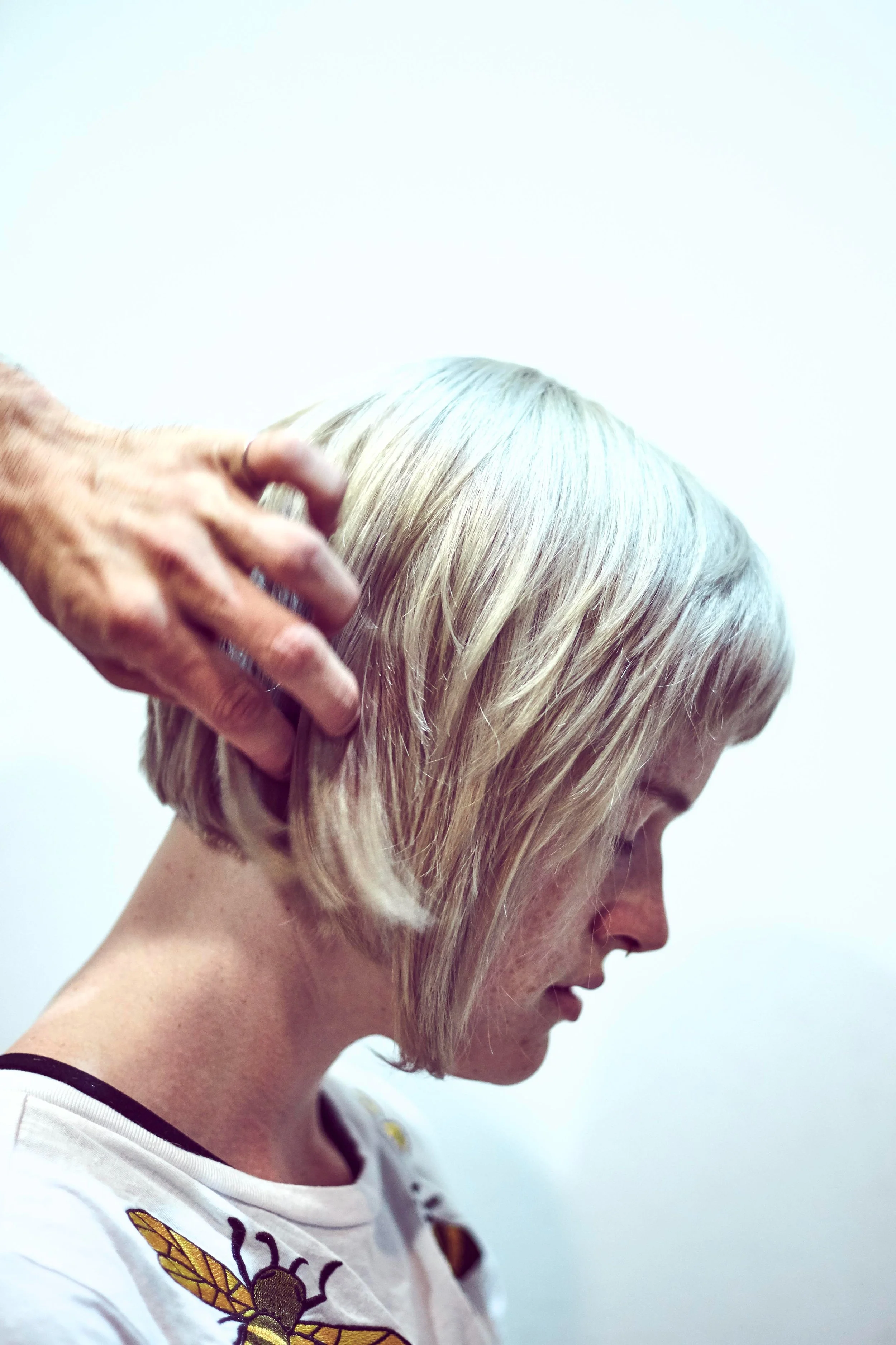 Woman receiving a haircut, side profile