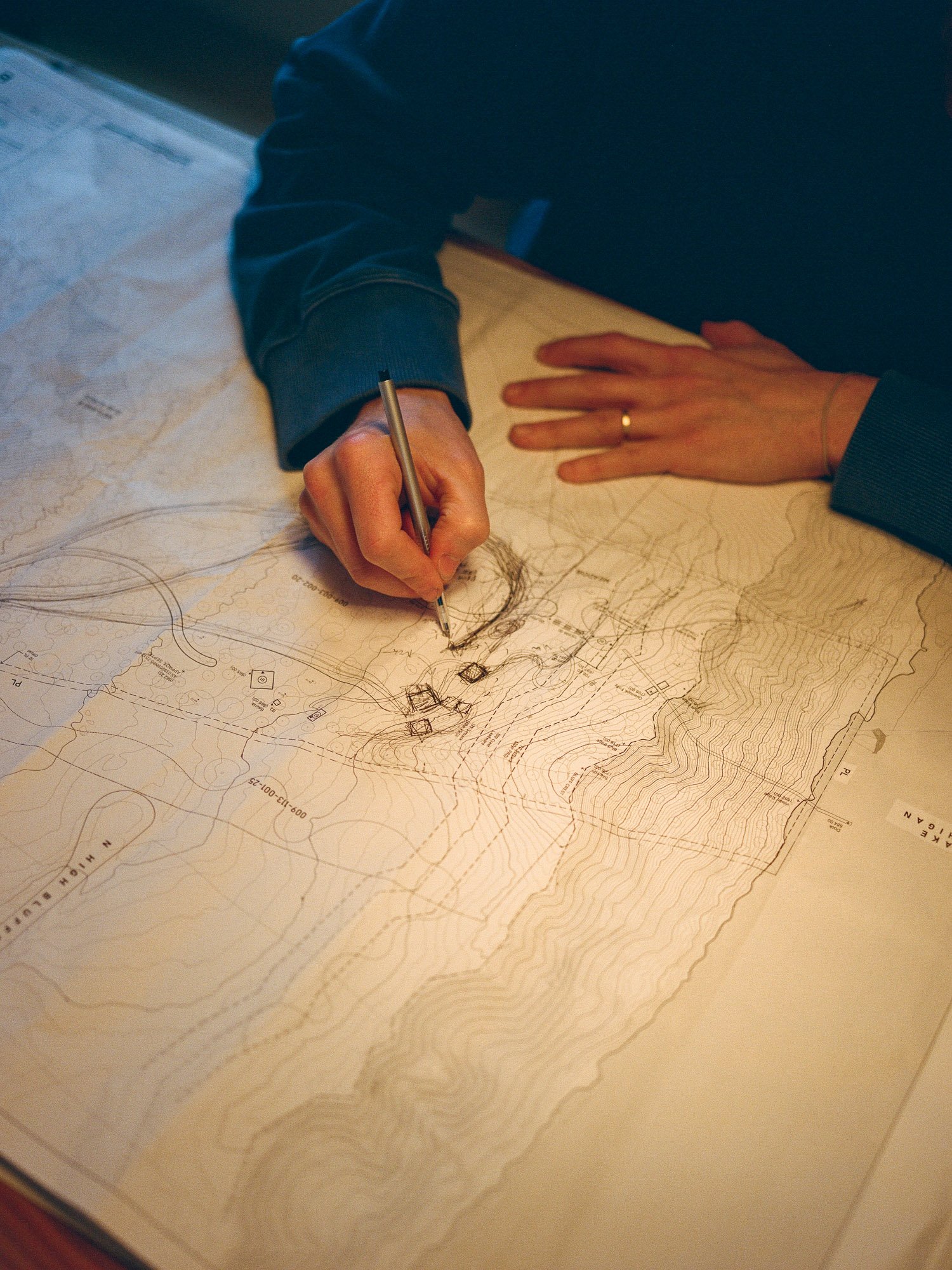Architect drawing on site plans.