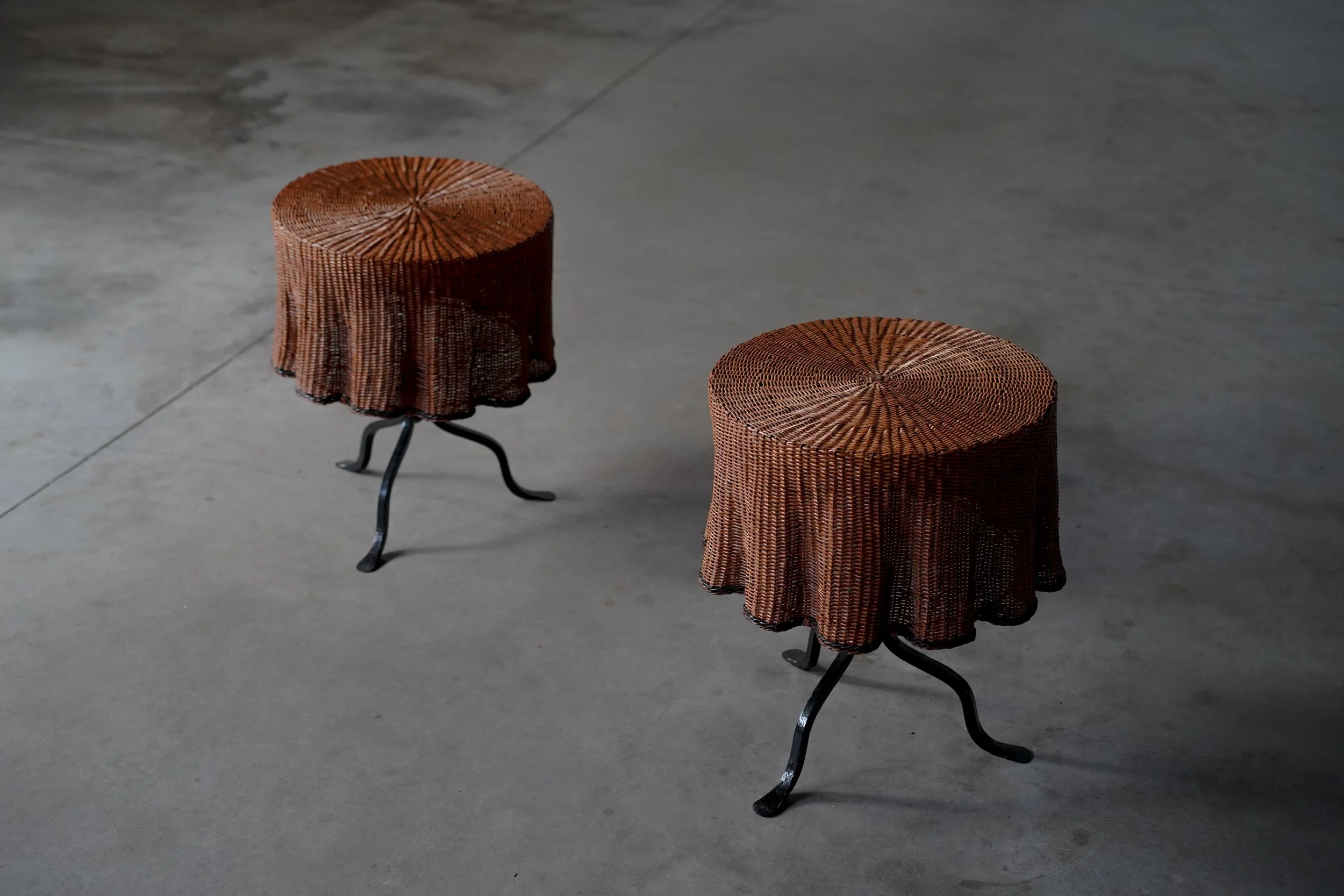 PAIR OF CAST IRON AND RATTAN SIDE TABLES