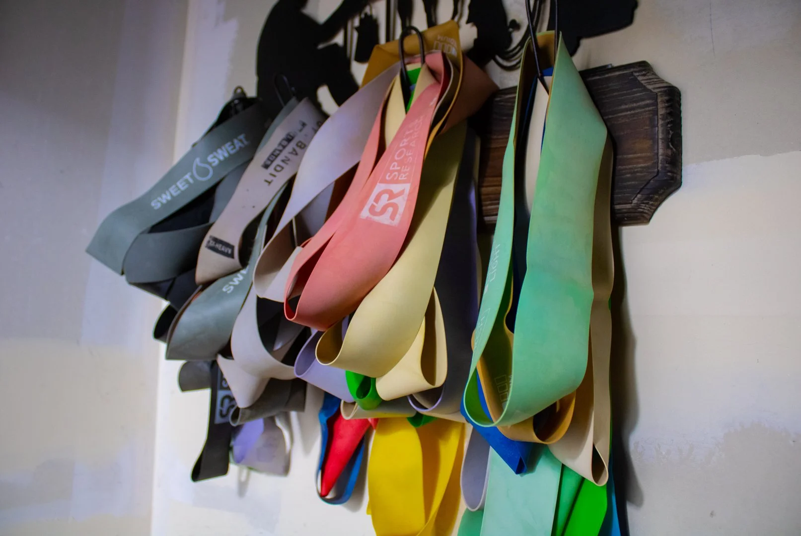 A photo of exercise bands hanging on a wall at Black Horse Yoga studio in Cle Elum, Washington, taken by Simply Social.