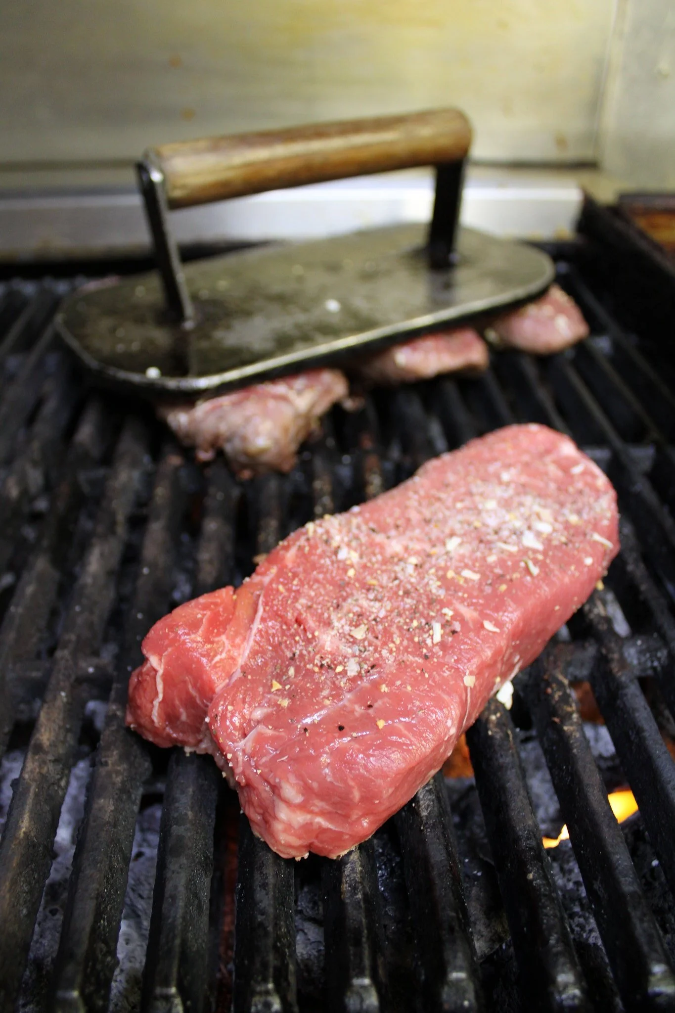 A photo of sirloin steaks on the grill at the Sunset Cafe and Loose Wolf Saloon in Cle Elum, taken by Simply Social.