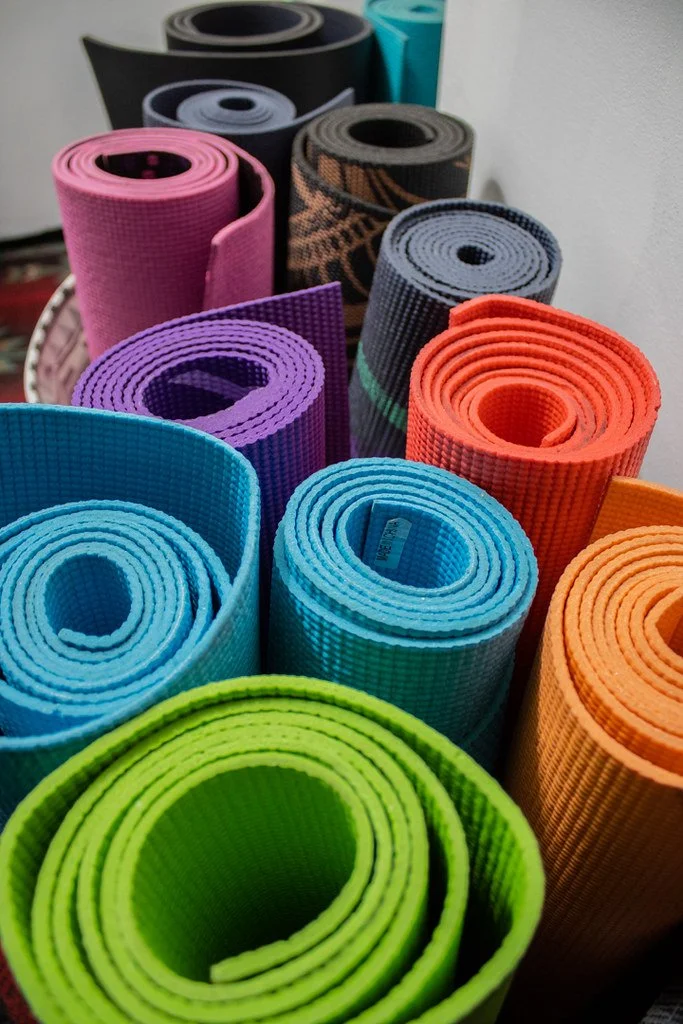 A photo of 11 colorful yoga mats at Black Horse Yoga in Cle Elum, Washington, taken by Simply Social.