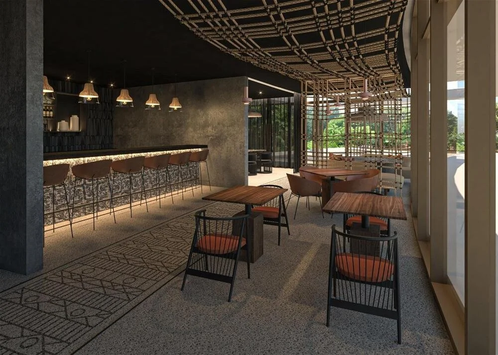 Modern cafe or restaurant interior with bar seating area, wooden tables and chairs, decorative ceiling design, and large windows letting in natural light.