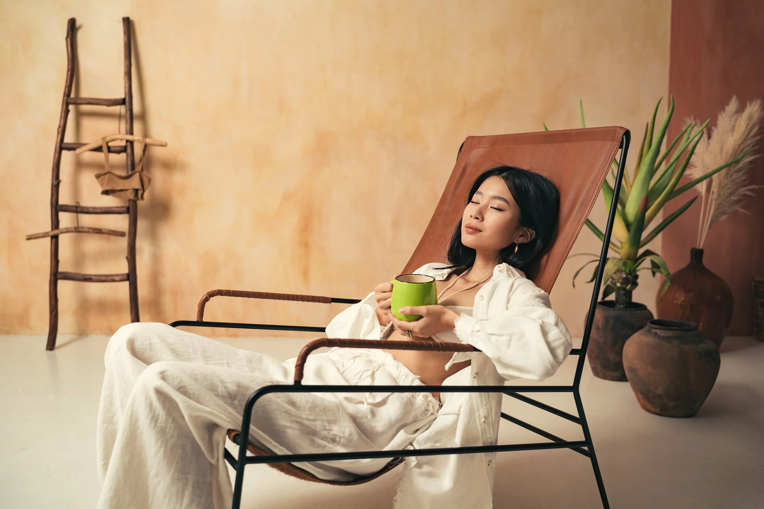 asian-girl-relaxing-on-lounger-with-mug-of-tea-me-2023-01-06-11-05-04-utc.jpeg