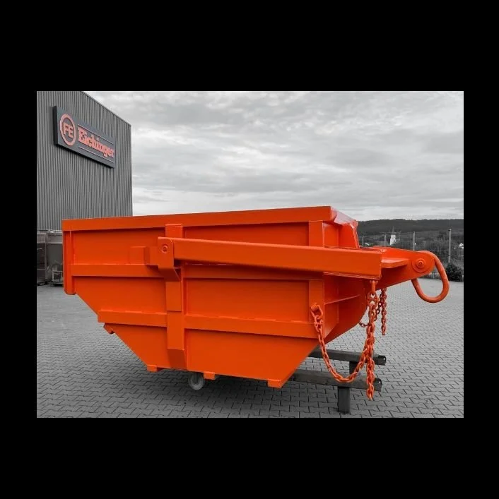 Eichingers Orange skip pan is at the factory with a gray background. This easy loading dump box is made of heavy duty steel and is rated at 10.4 yards.