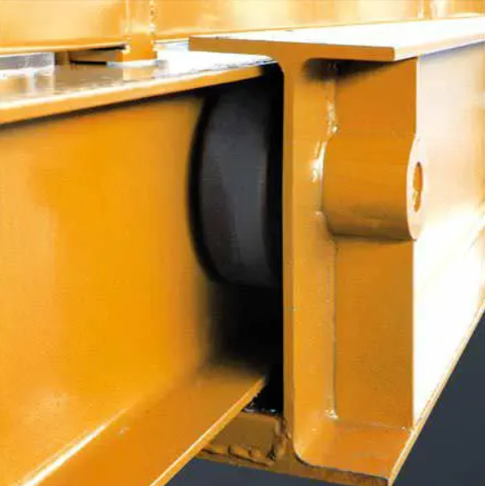 large retractable outrigger. This is a close up picture of the orange steel structure with a black roller wheel that supports the retractable deck in the picture.